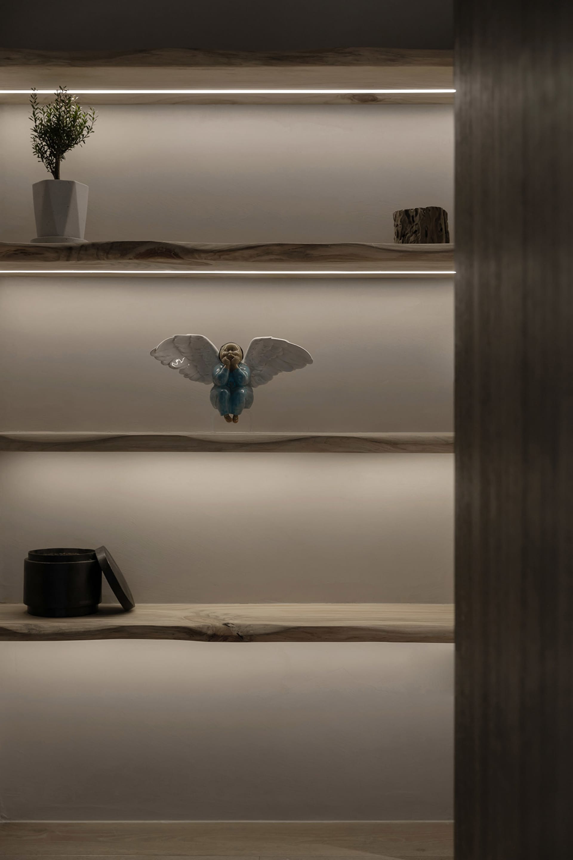A modern shelf display featuring wooden shelves with built-in lighting.