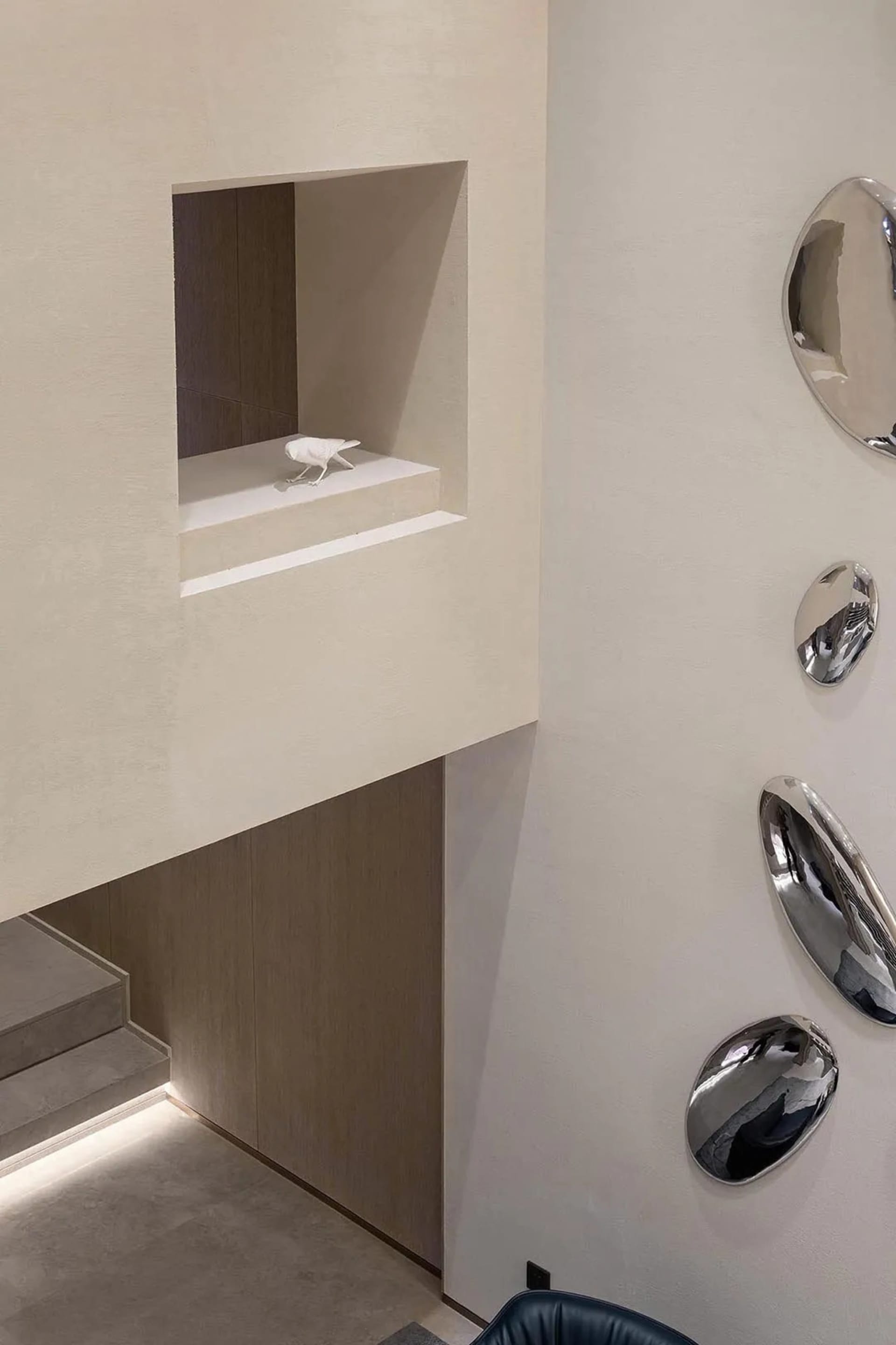 A minimalist entryway featuring concrete materials and geometric shapes.