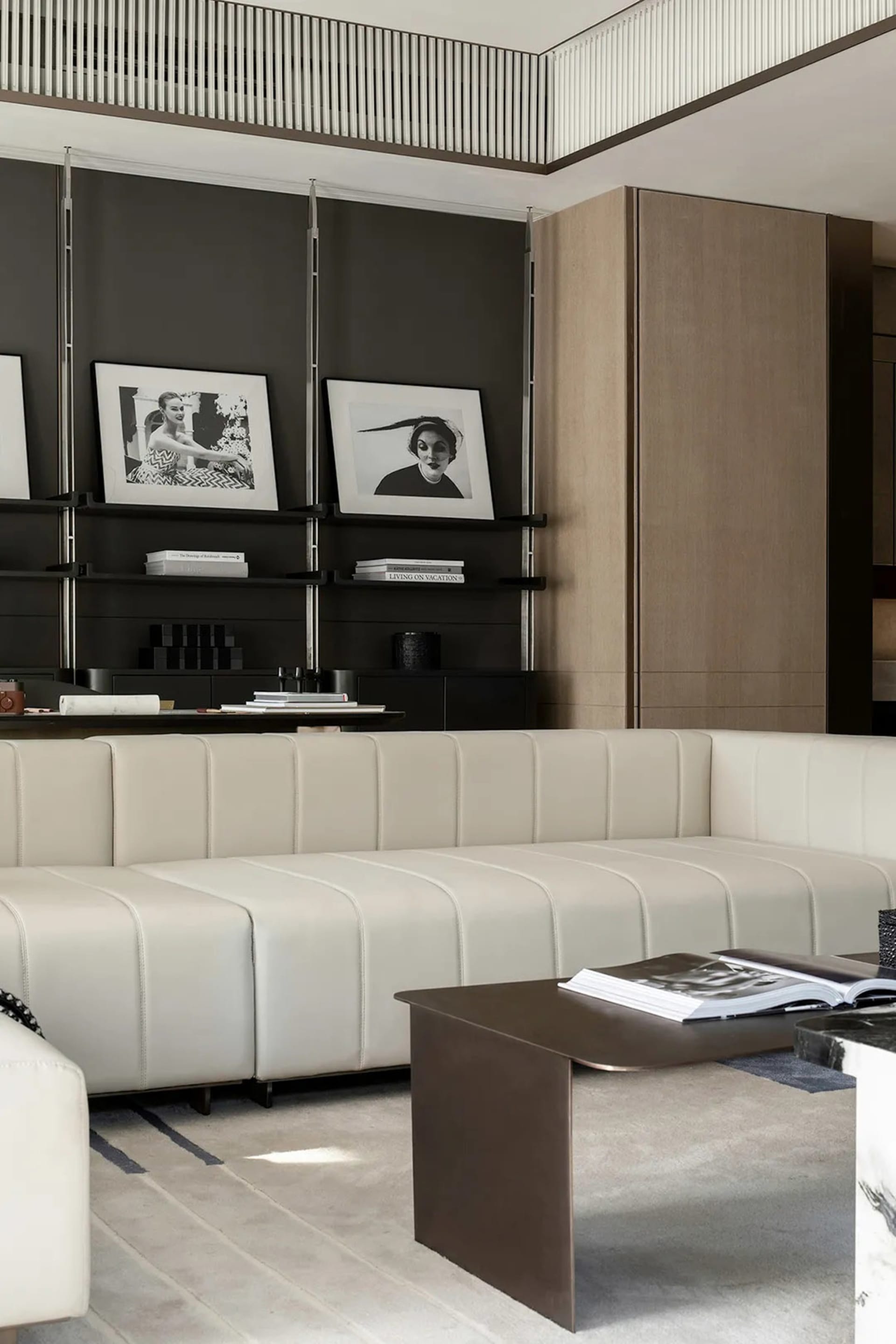 Modern minimalist living room featuring a white leather sectional sofa and a metallic coffee table.