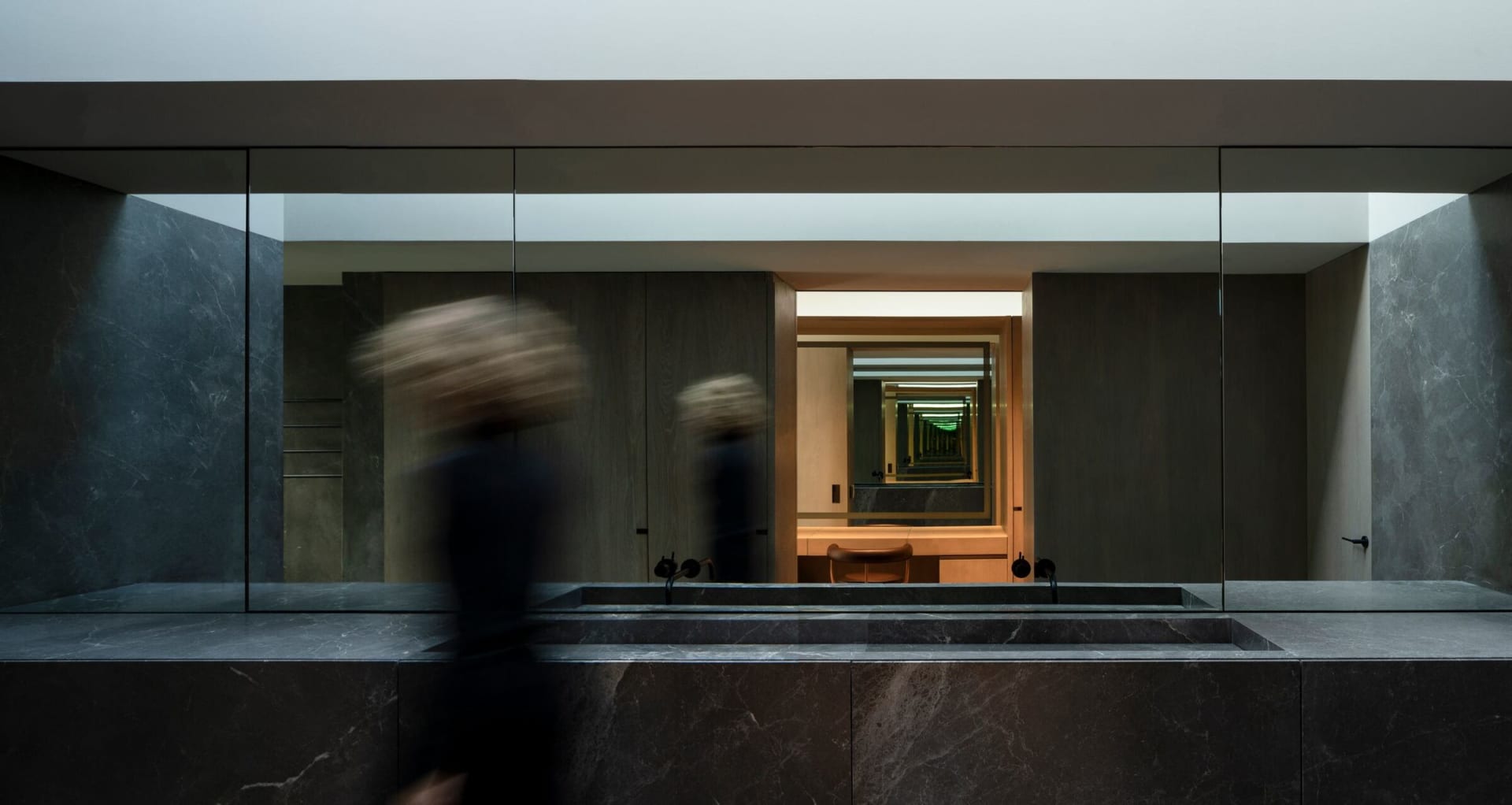 Modern bathroom with black marble walls