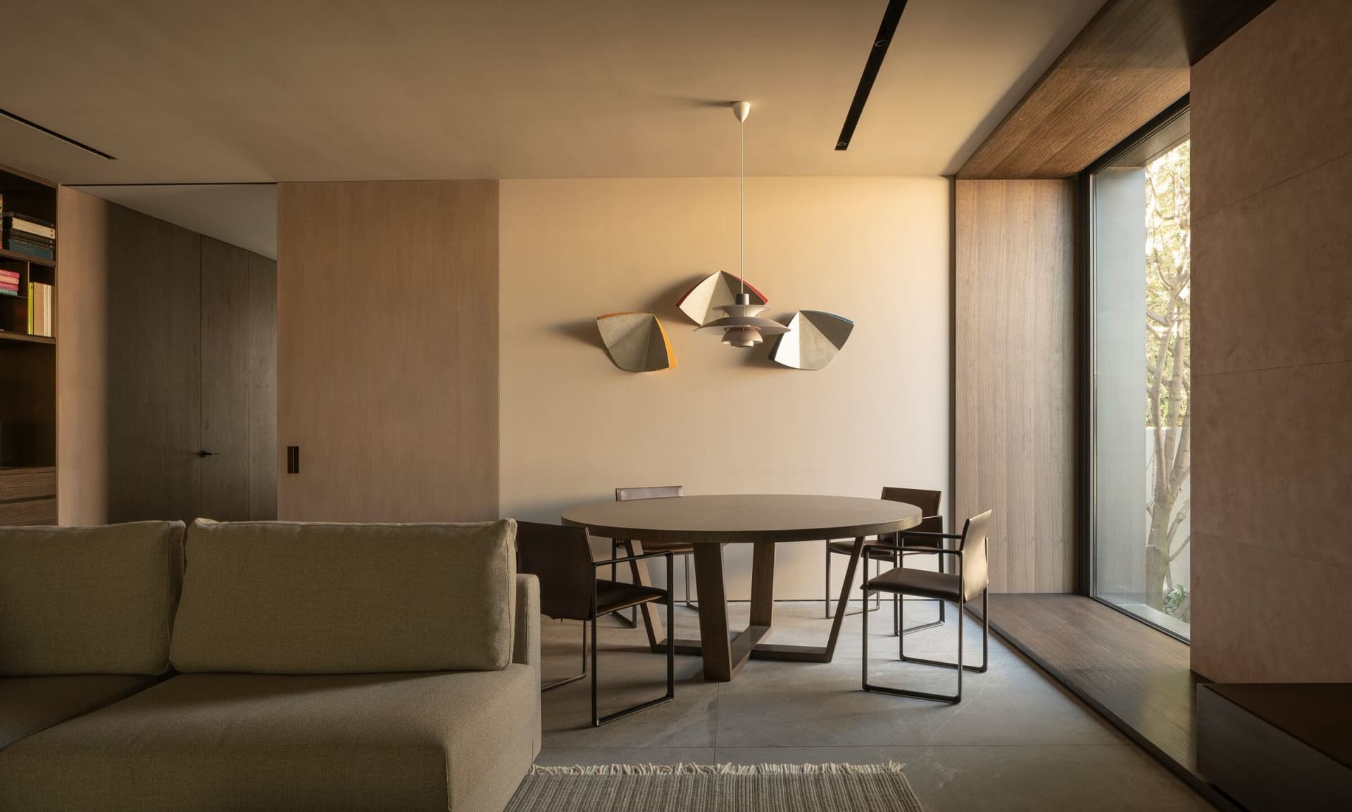 Modern residential dining room with wood and metal furniture.