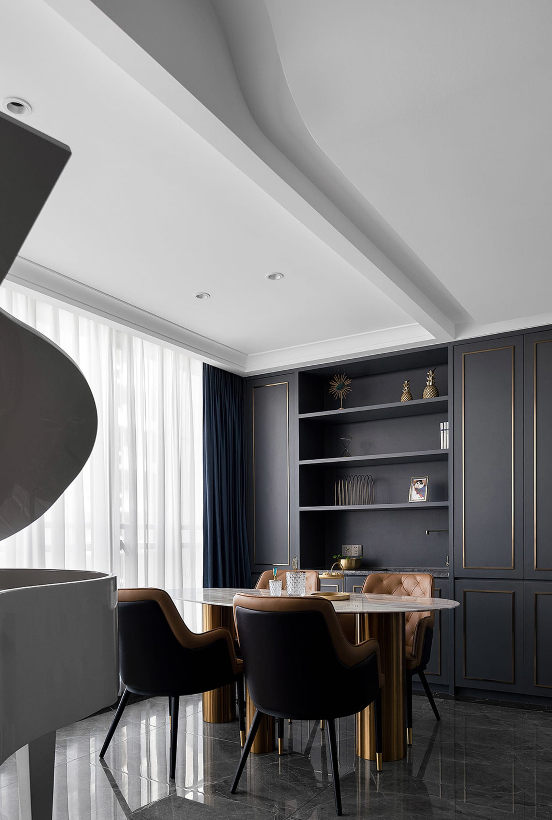 Modern dining room featuring marble table and metal chairs.