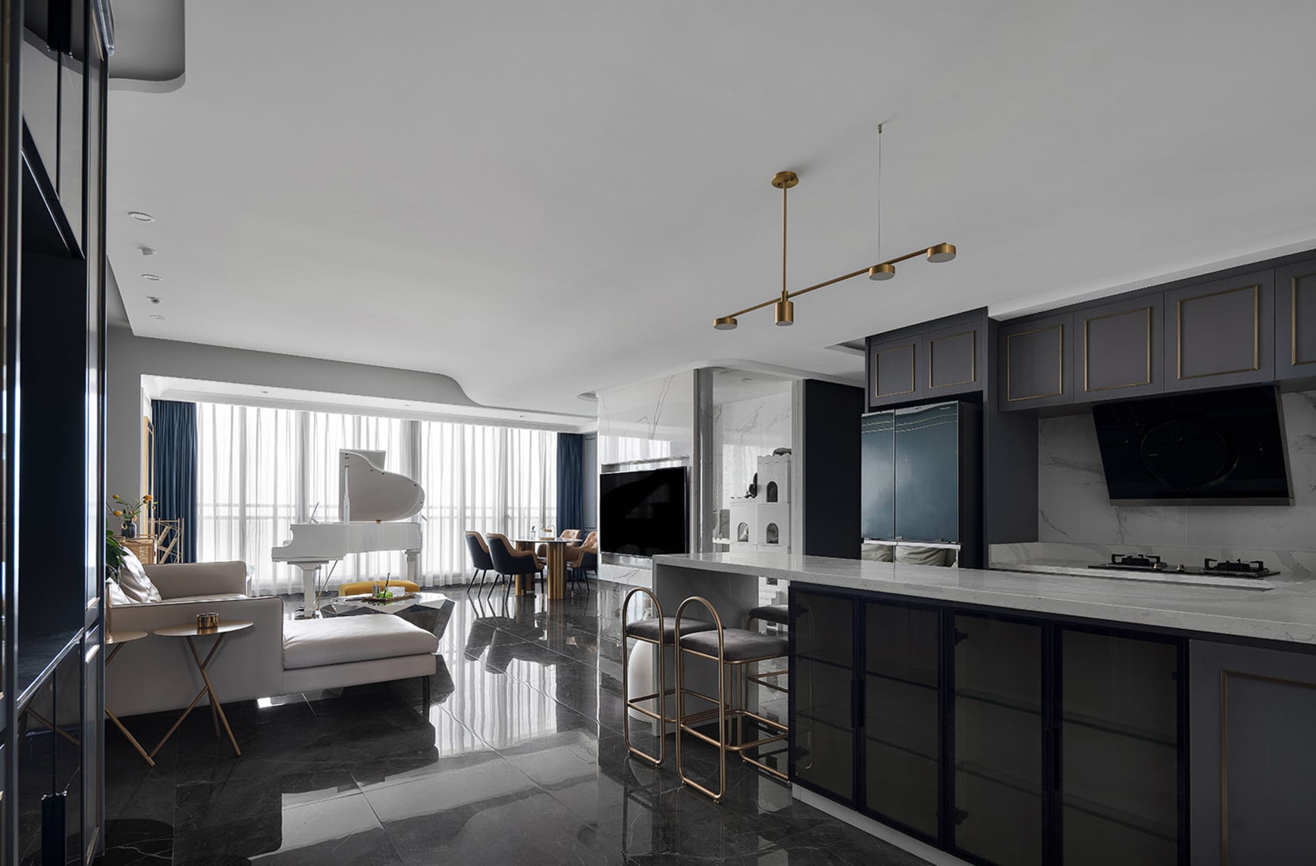 A modern kitchen with black marble flooring and cabinets