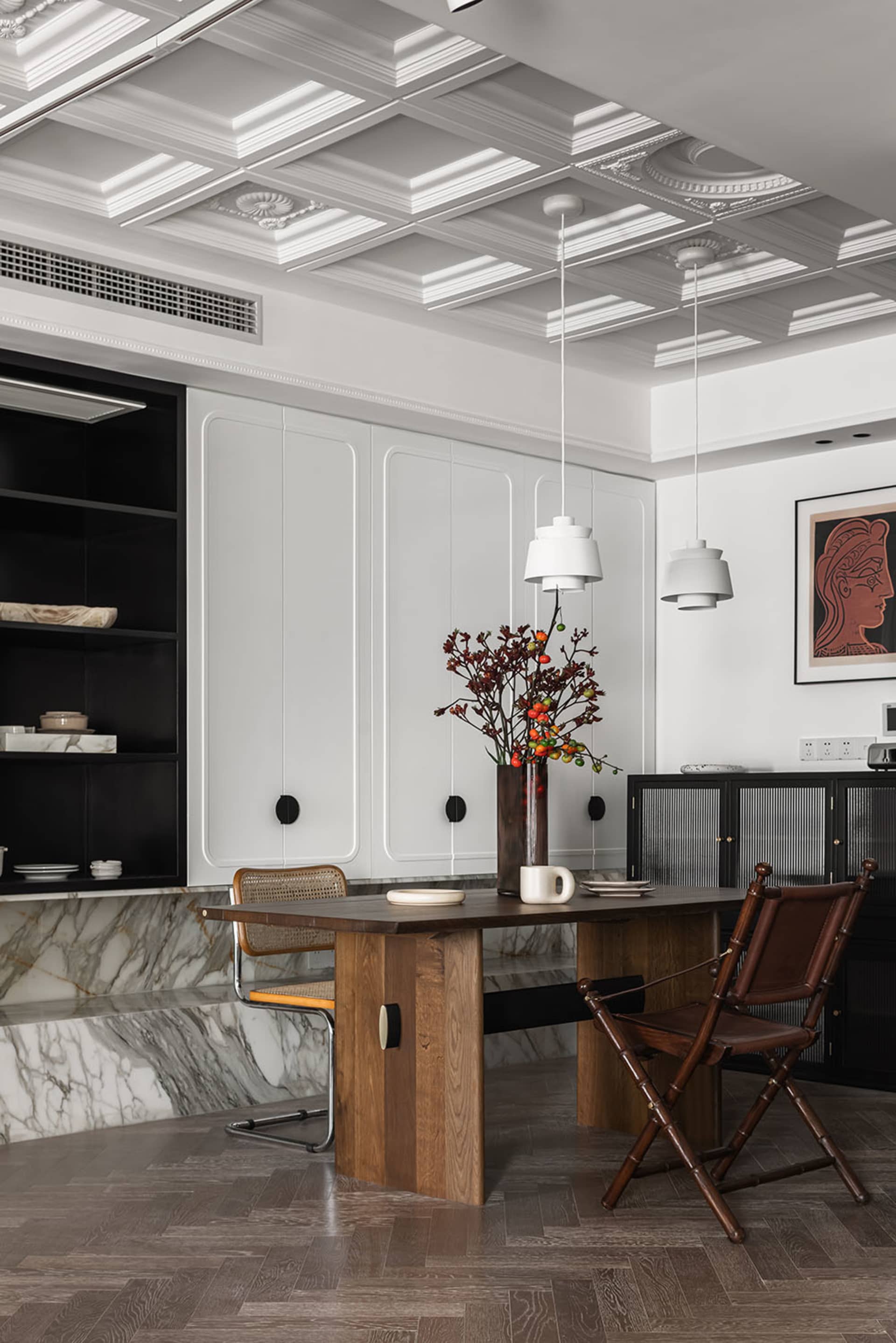 Modern dining room with a wooden table and marble accents. Modern design elements include sleek, minimalist chairs and clean