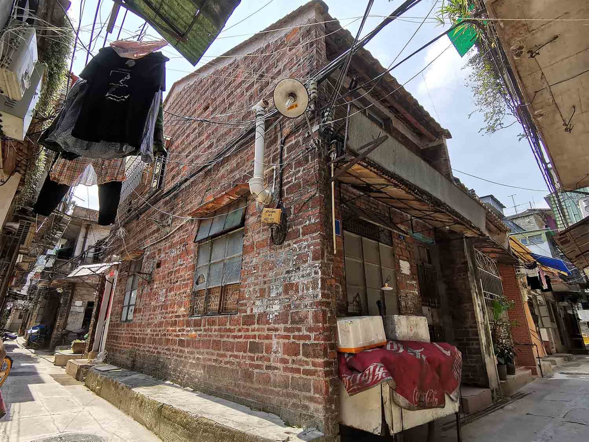 A photograph of a brick alleyway with urban furniture.