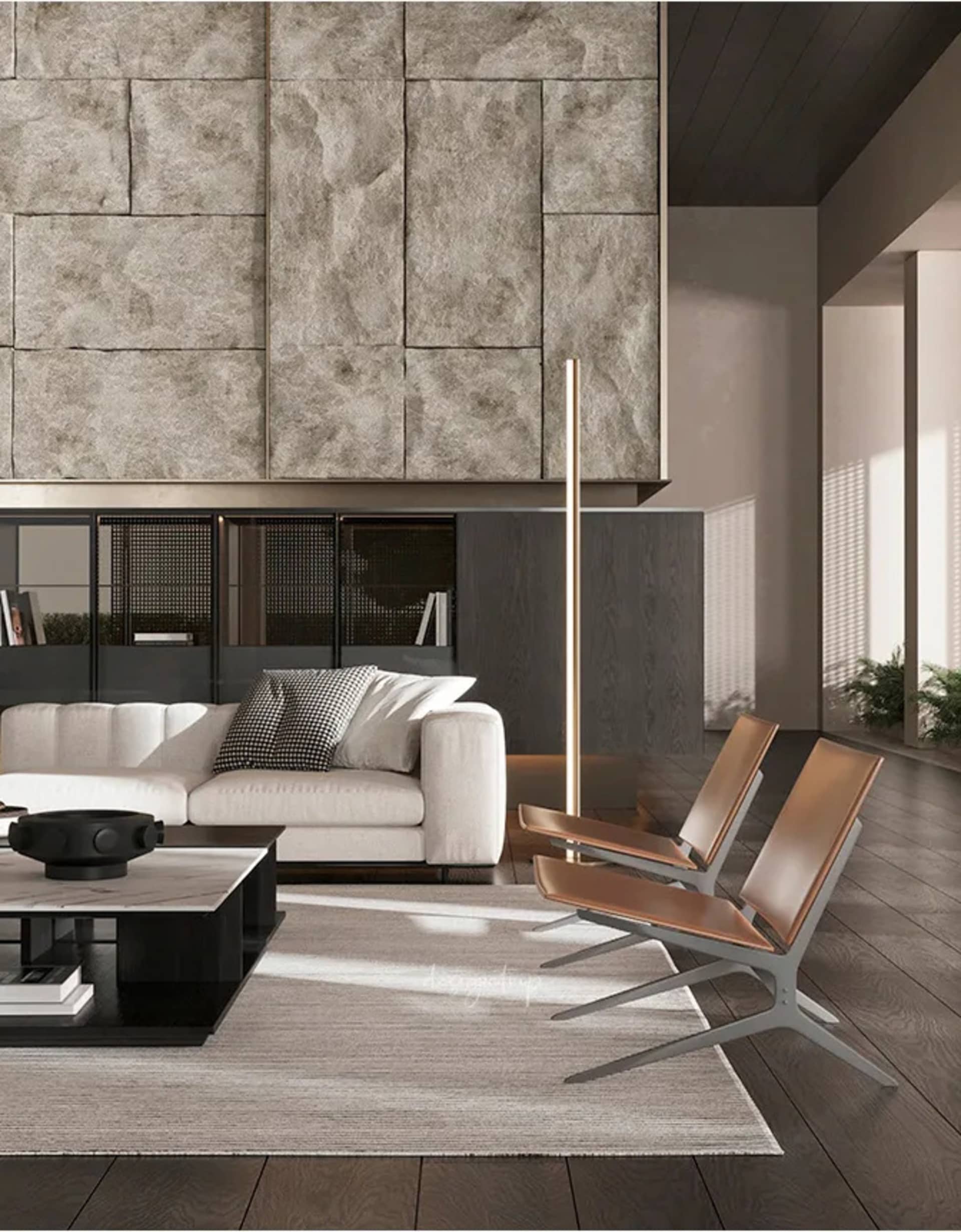 Modern living room with a white sofa, metal and leather chairs, and a wooden floor.