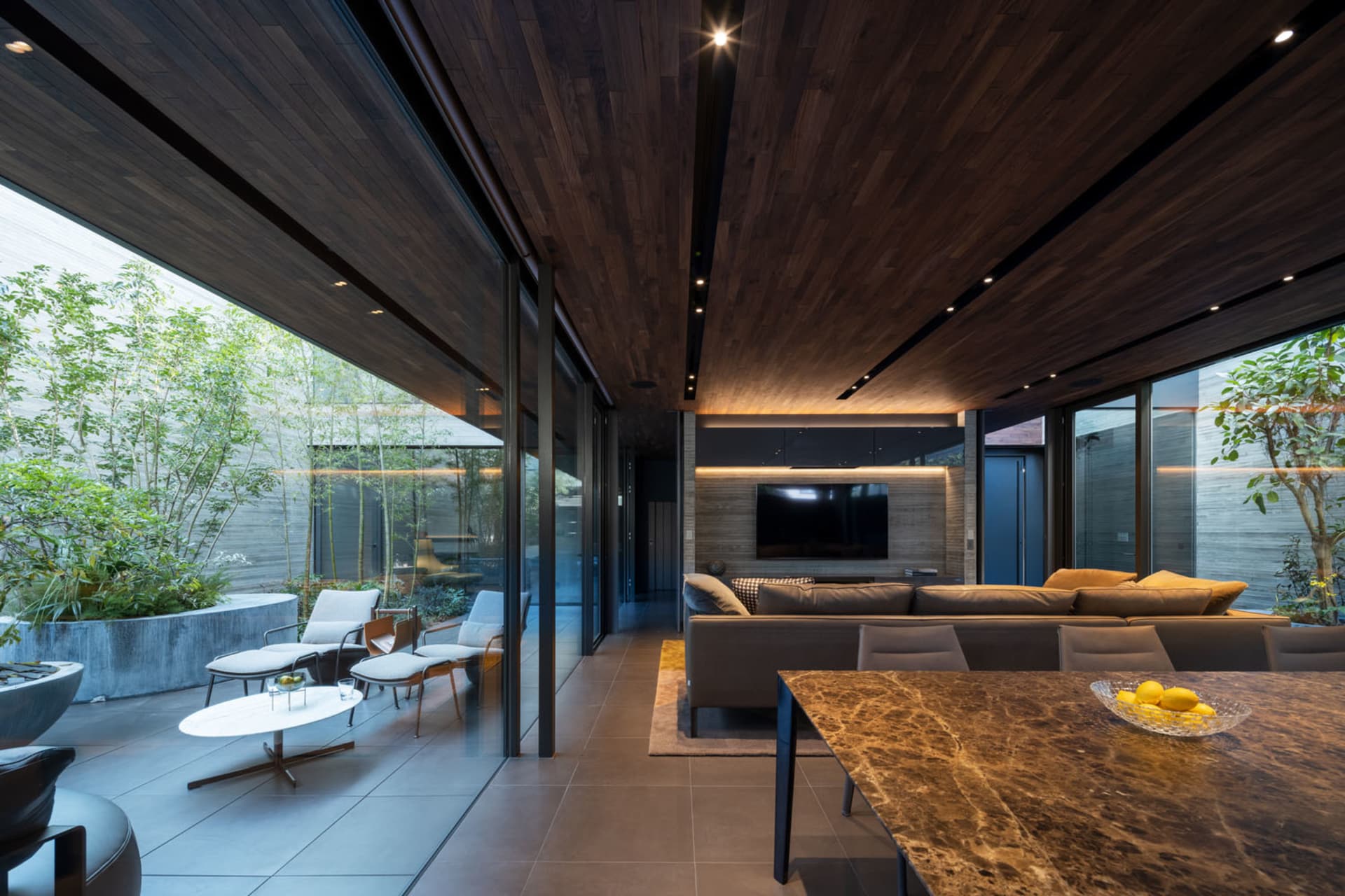 Industrial minimalist living room featuring wood, concrete, and masonry materials.
