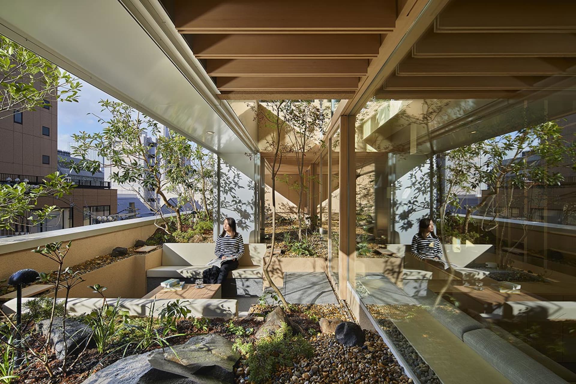 A modern coffee shop interior featuring wet-look concrete floors and glass elements.