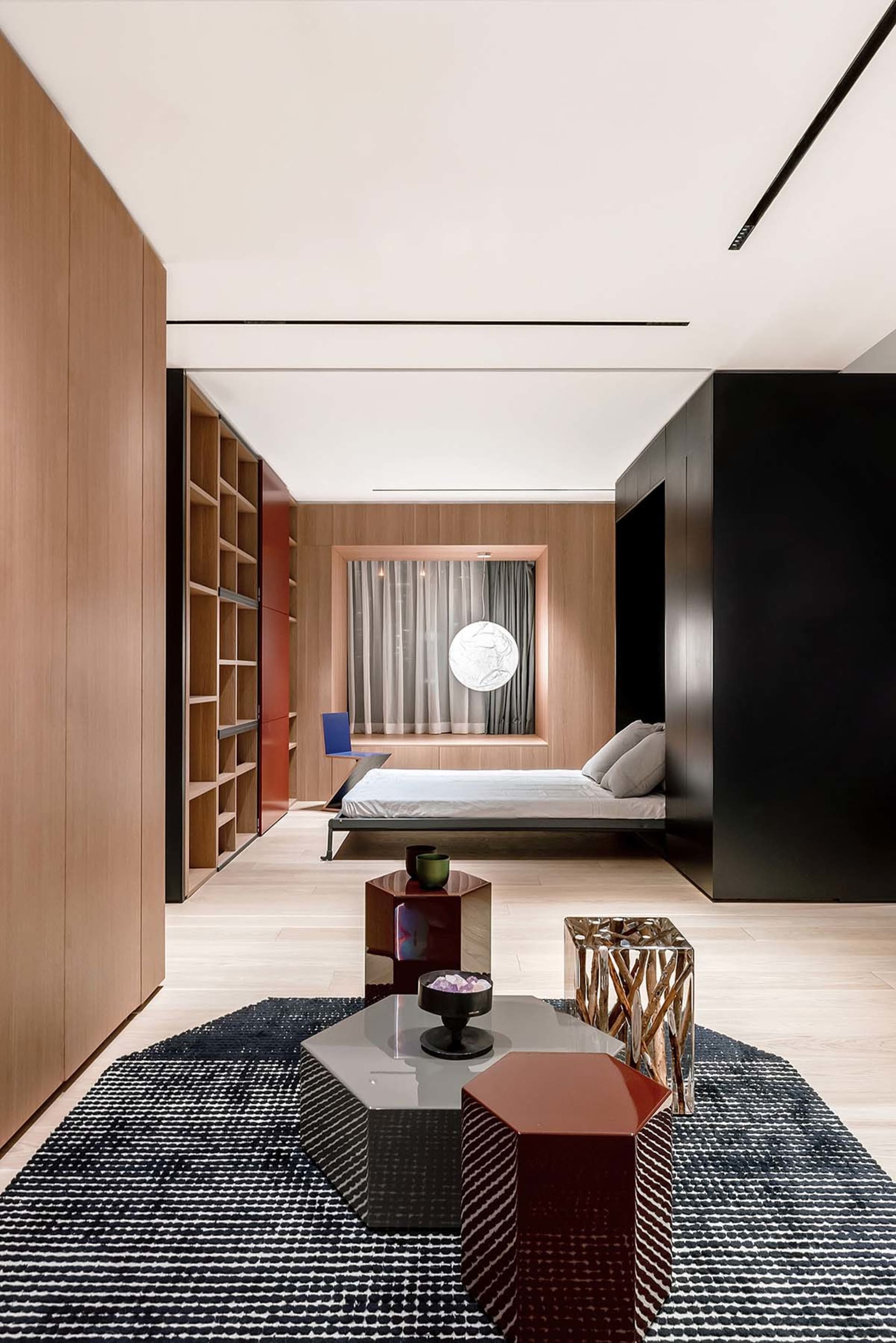 Modern minimalist bedroom featuring wooden panels, glass accents, and metal furniture.