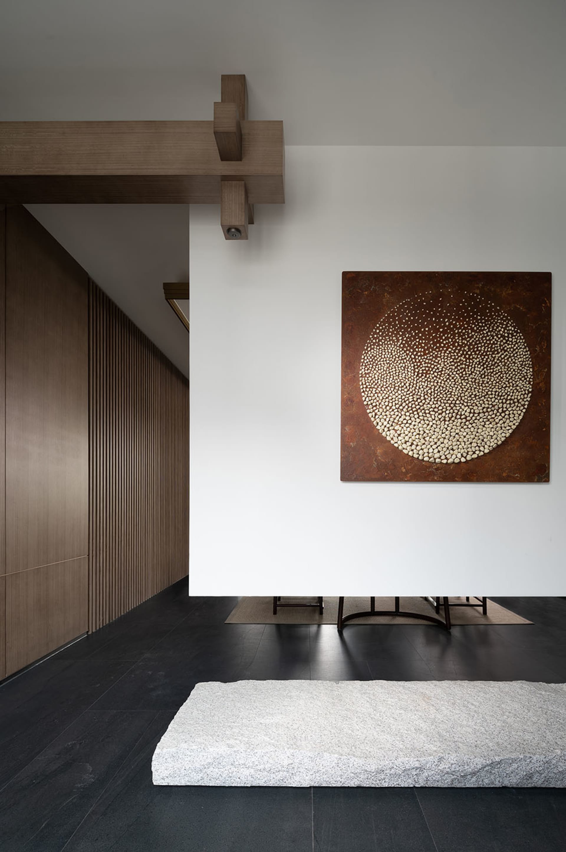 A modern interior space featuring wood paneling and a concrete floor
