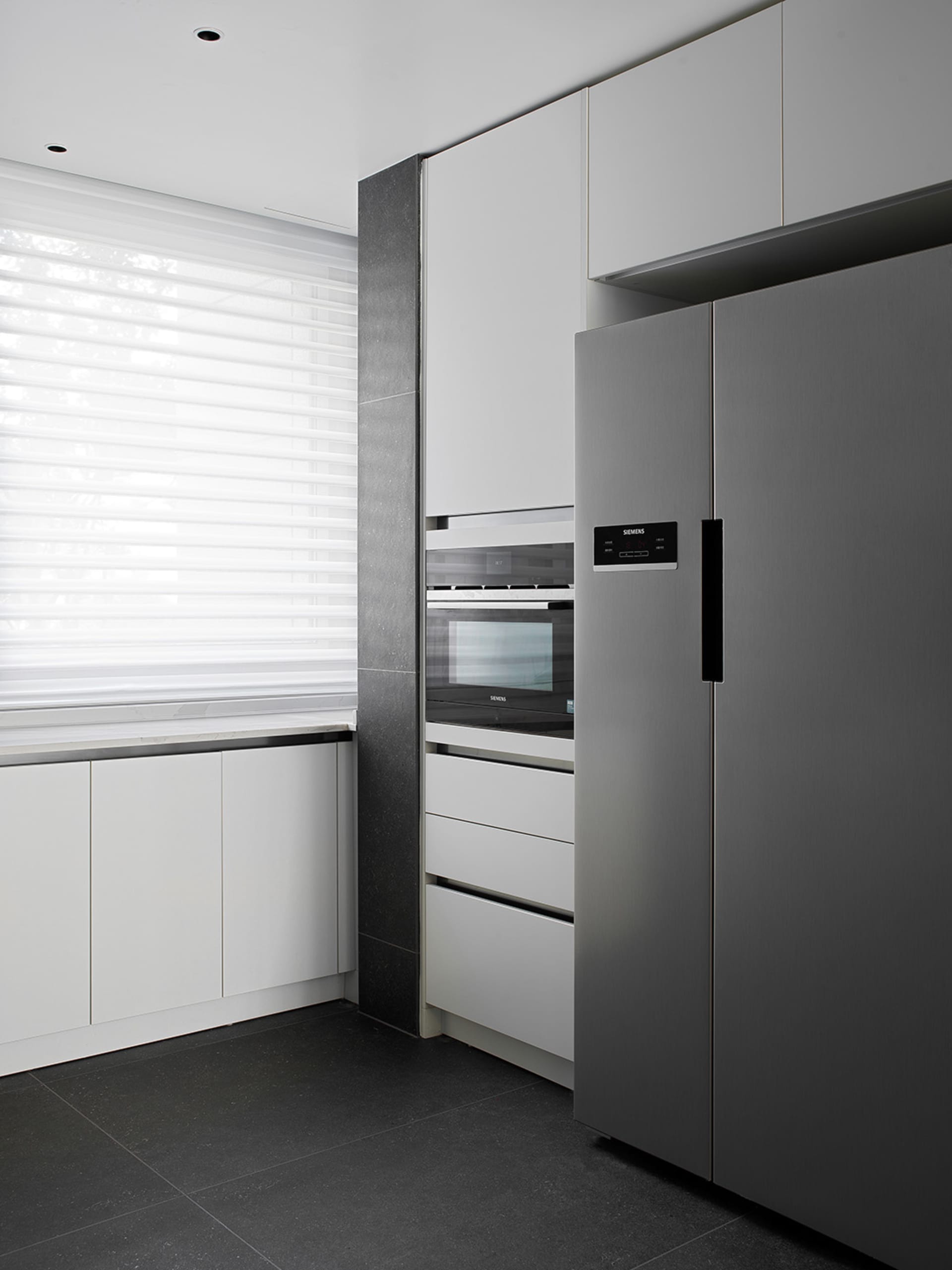 A contemporary kitchen with sleek metal appliances and minimalist design features.