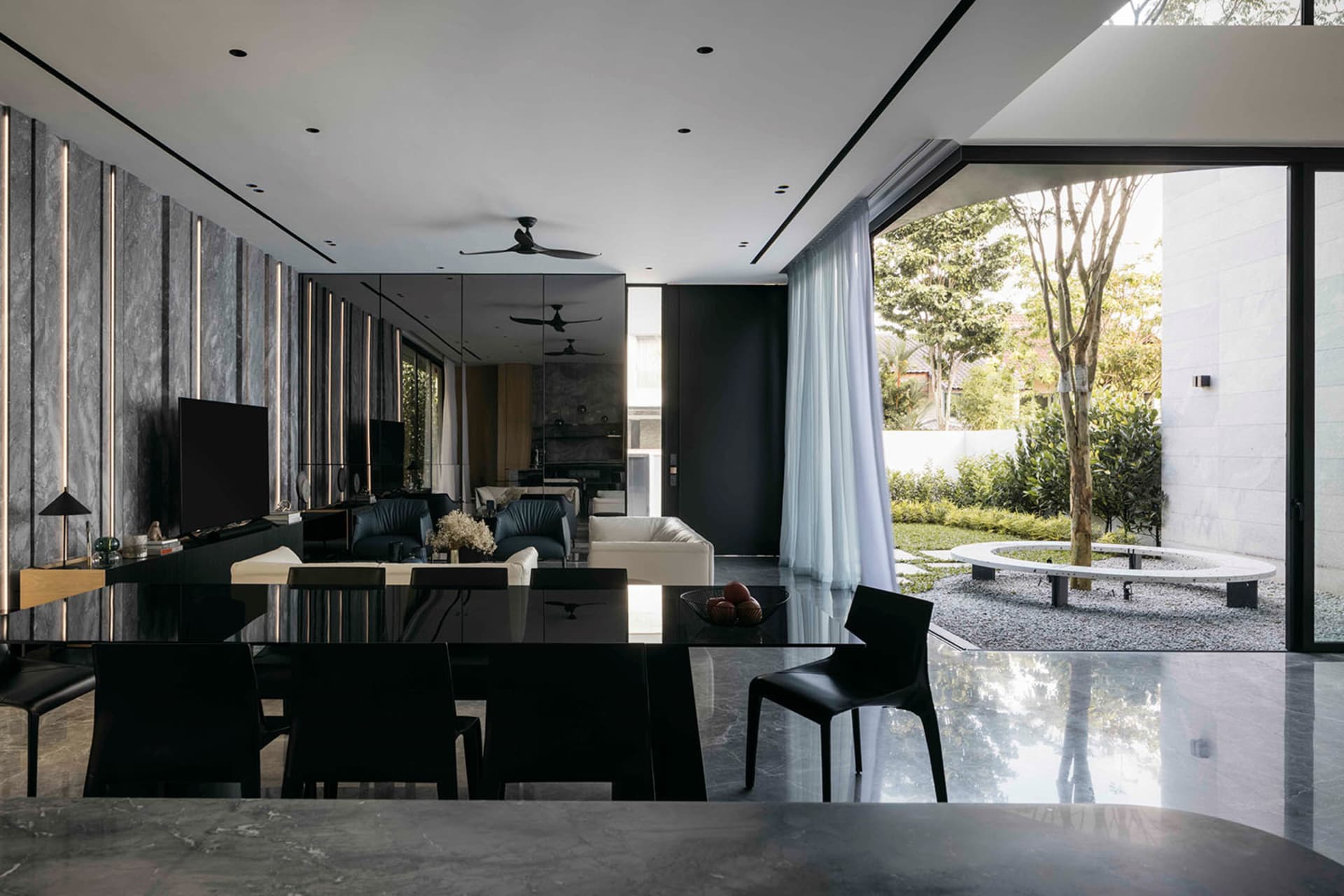 Contemporary living room featuring concrete walls and metal accents