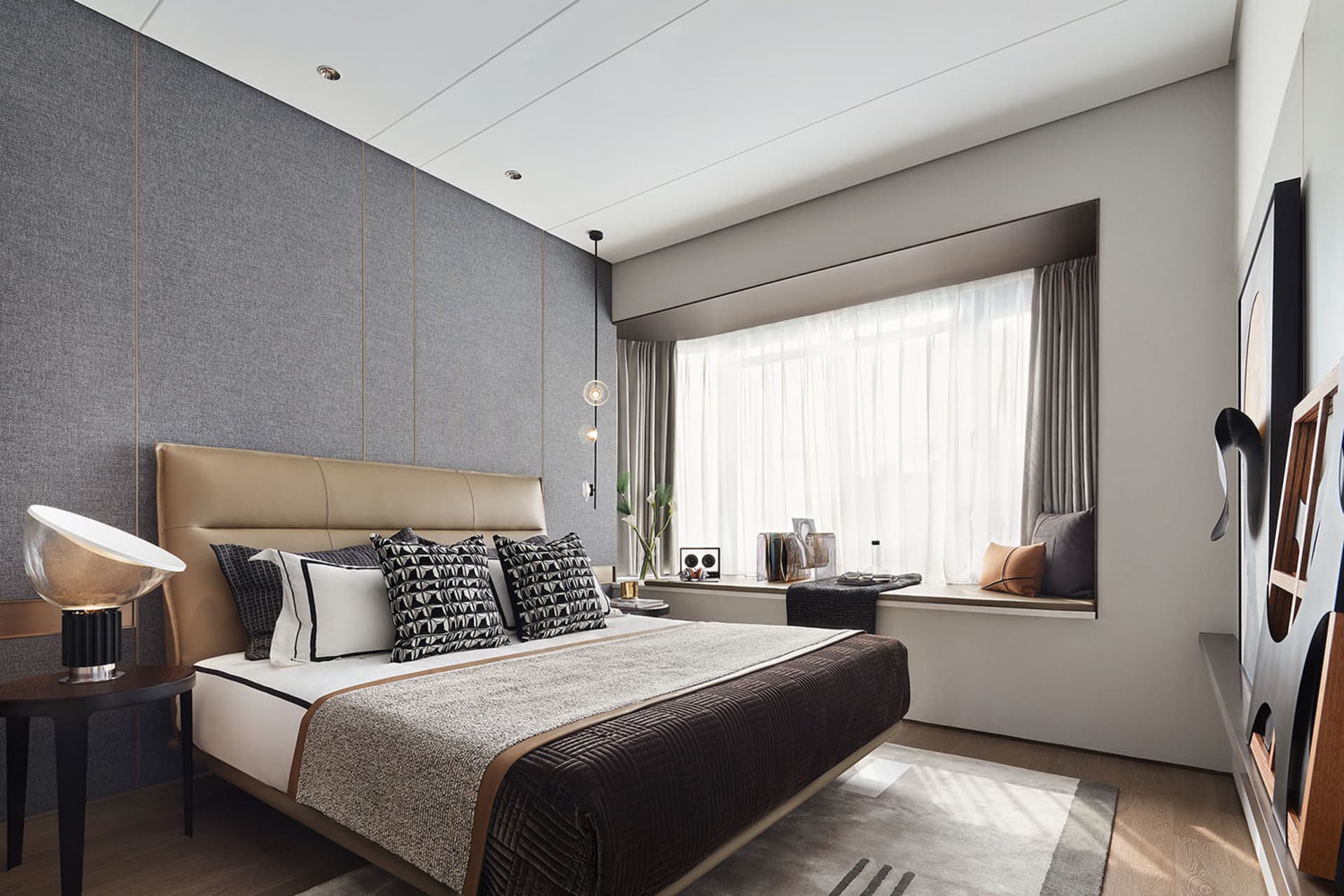 A modern bedroom featuring a bed with fabric upholstery, wooden headboard, and metal accents, situated next to a window with
