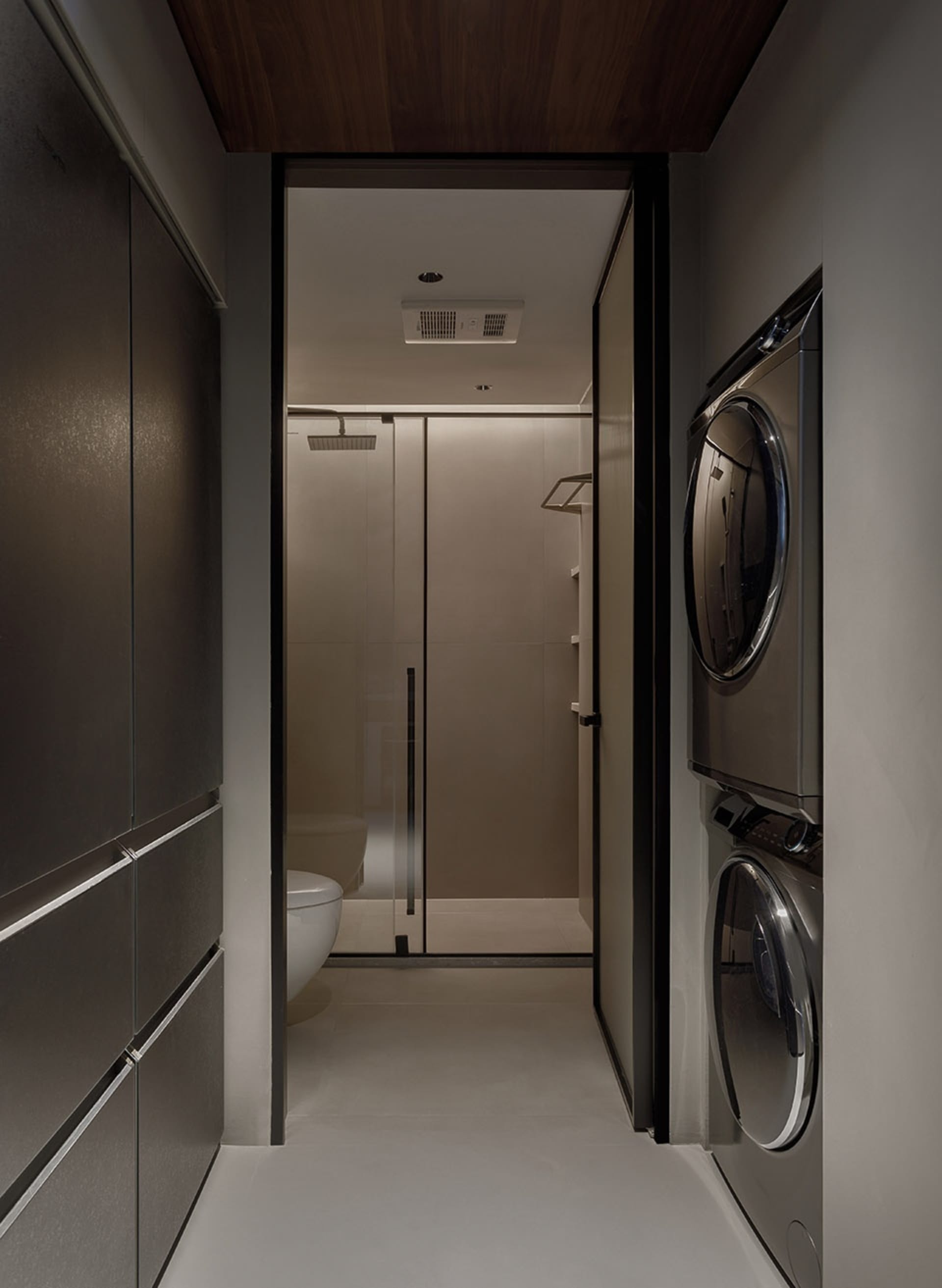 A minimalist laundry room with metallic finishes and a sleek, efficient design.