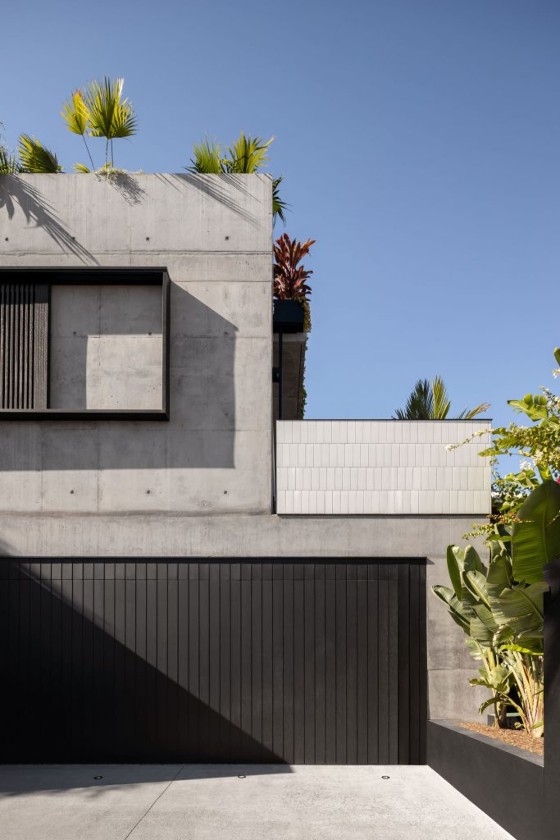 Modern building with concrete exterior and green top garden