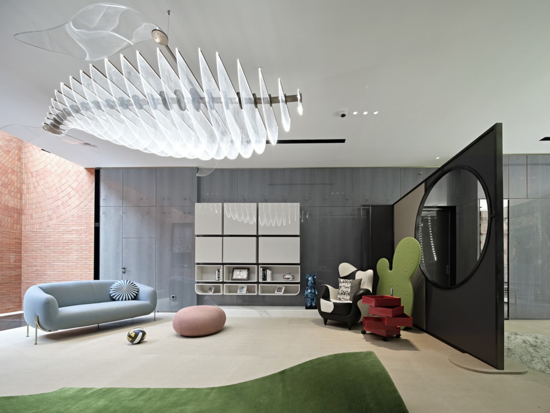 Modern living room with glass walls, metal accents, and fabric furnishings in white and black tones.