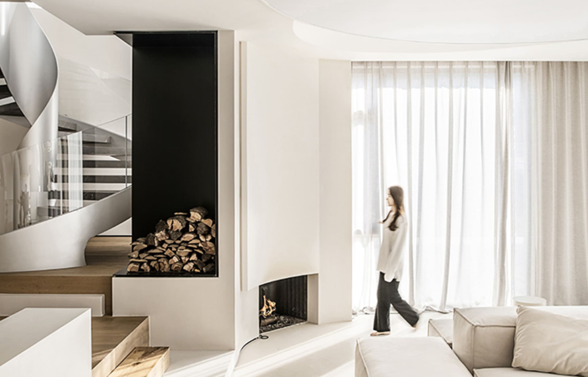 A minimalist living room with concrete walls and wooden furniture