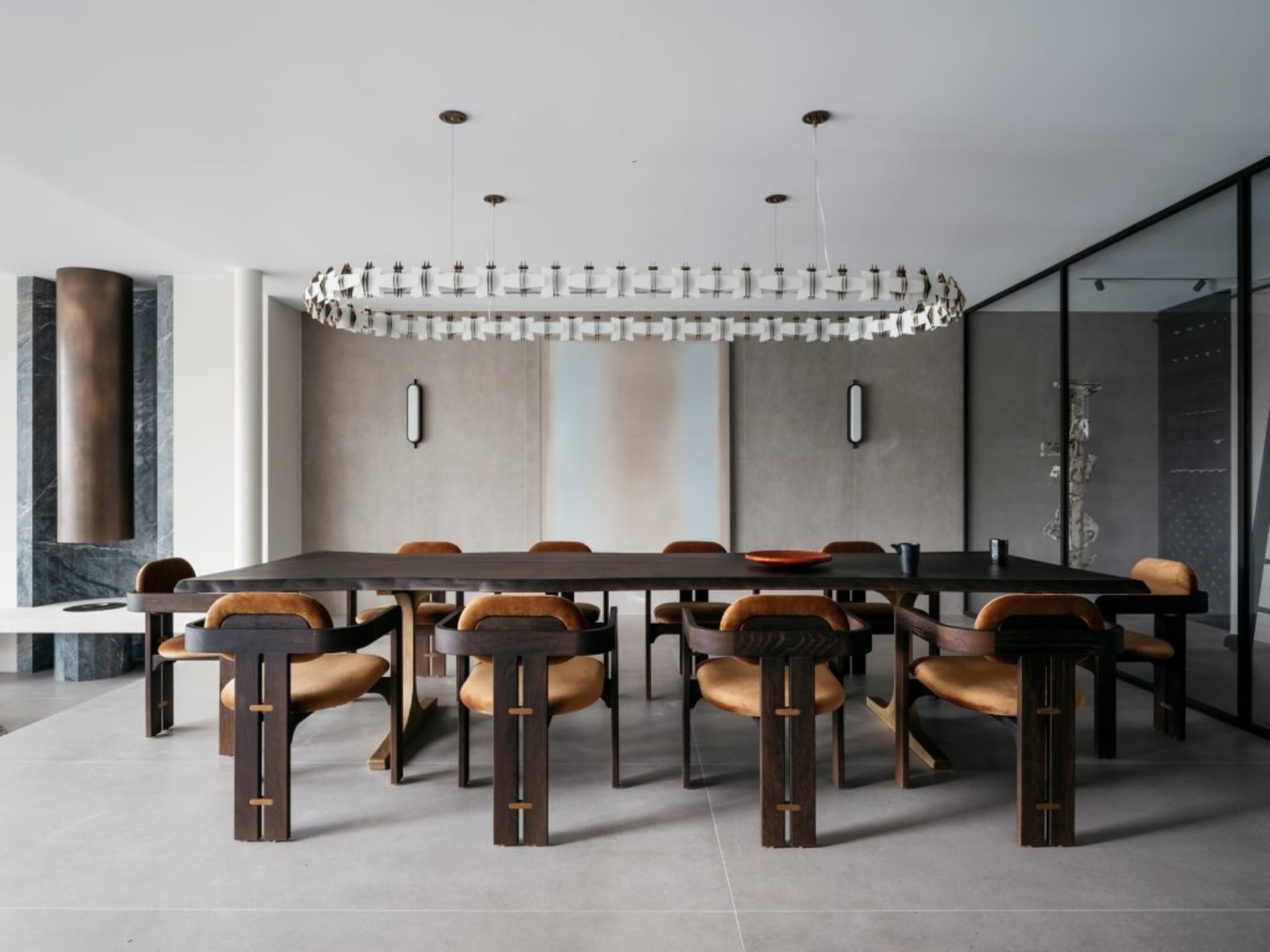 Contemporary dining room featuring wooden furniture, minimalist design, and a circular chandelier.