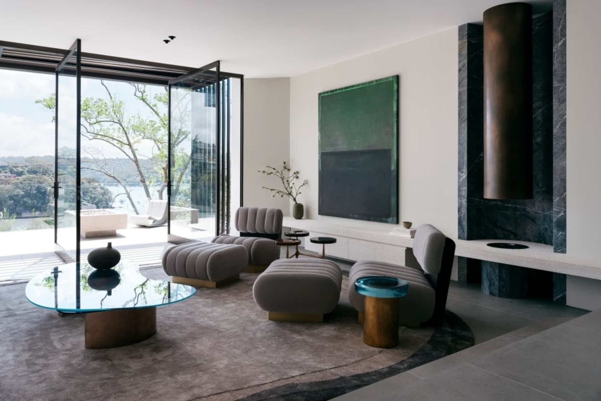 A modern living room featuring marble and glass elements.
