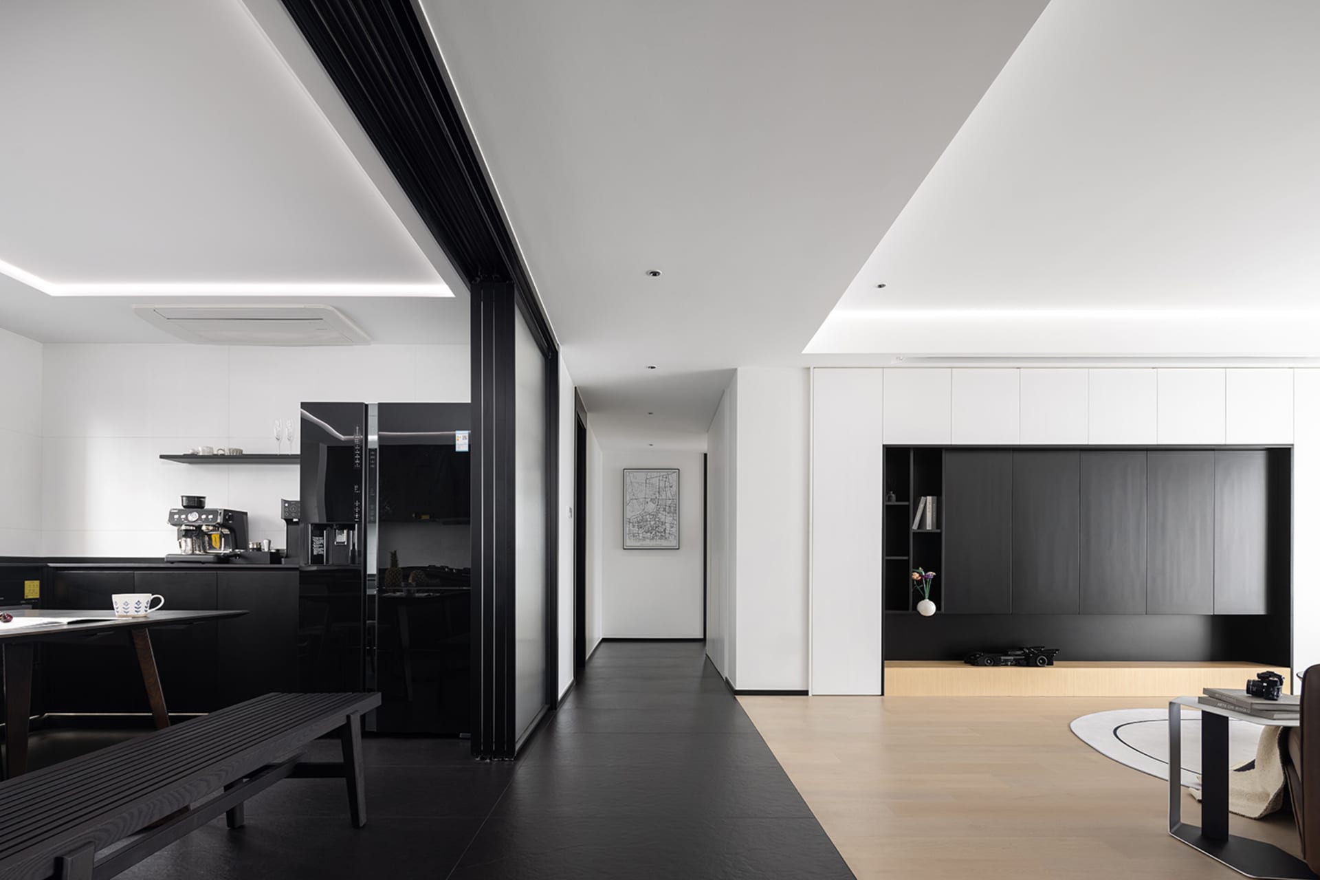 Modern interior space with white walls, black flooring, and black materials.