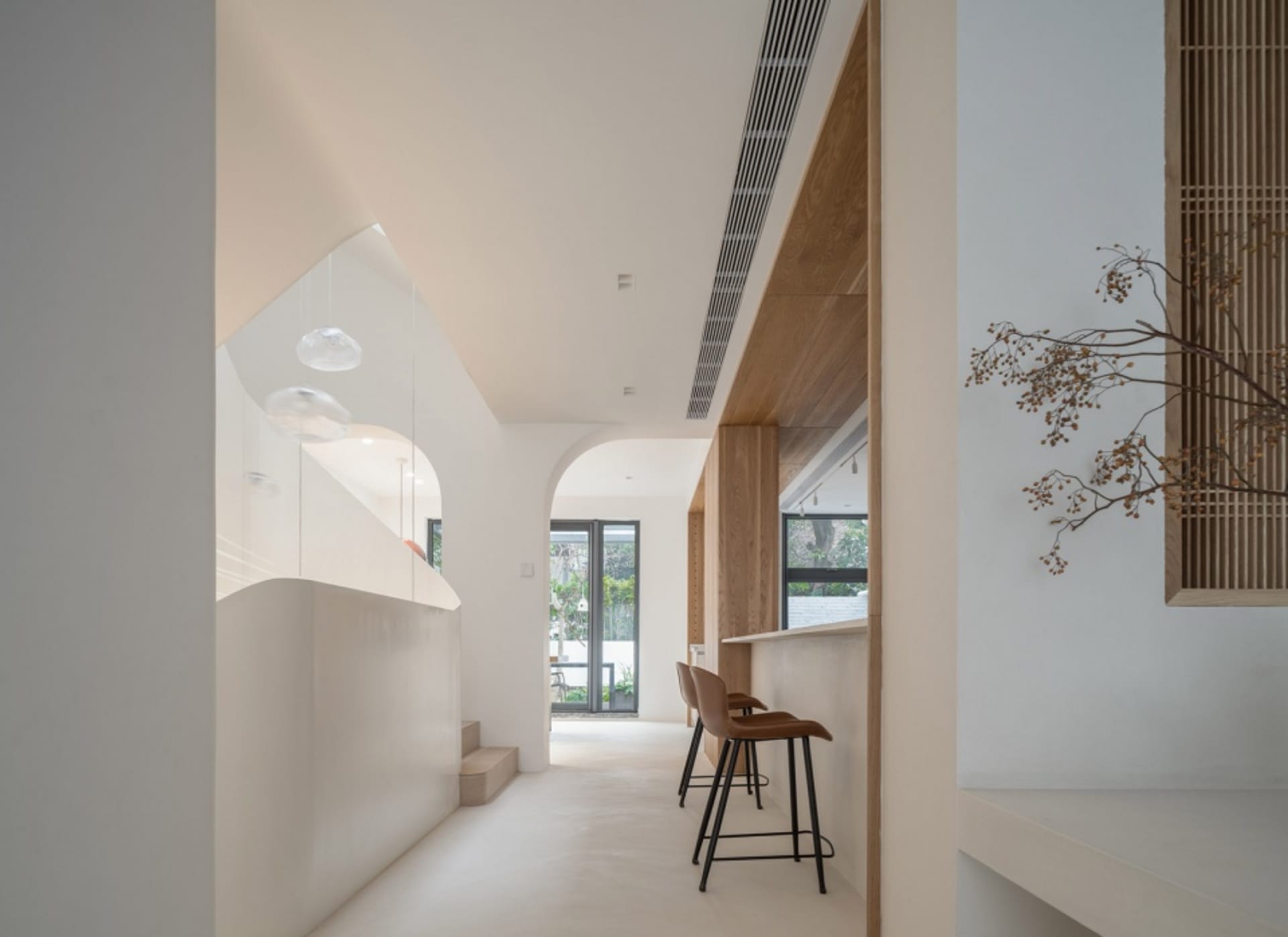 A modern kitchen bar area featuring white cabinets and a sleek design.