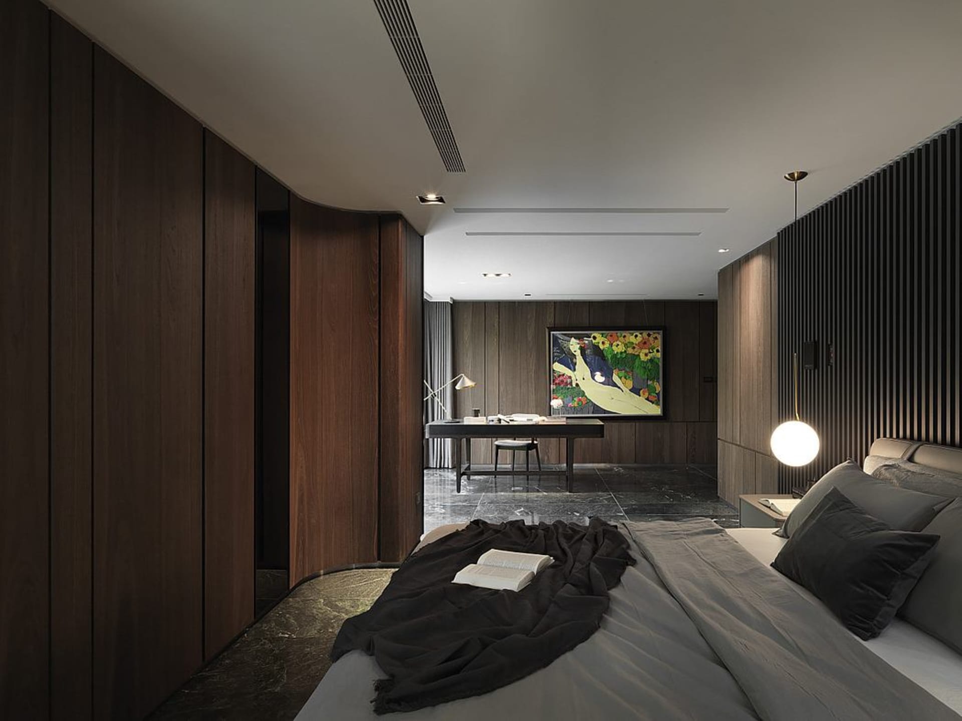 A modern bedroom featuring wooden walls, a grey bed, and a light fixture