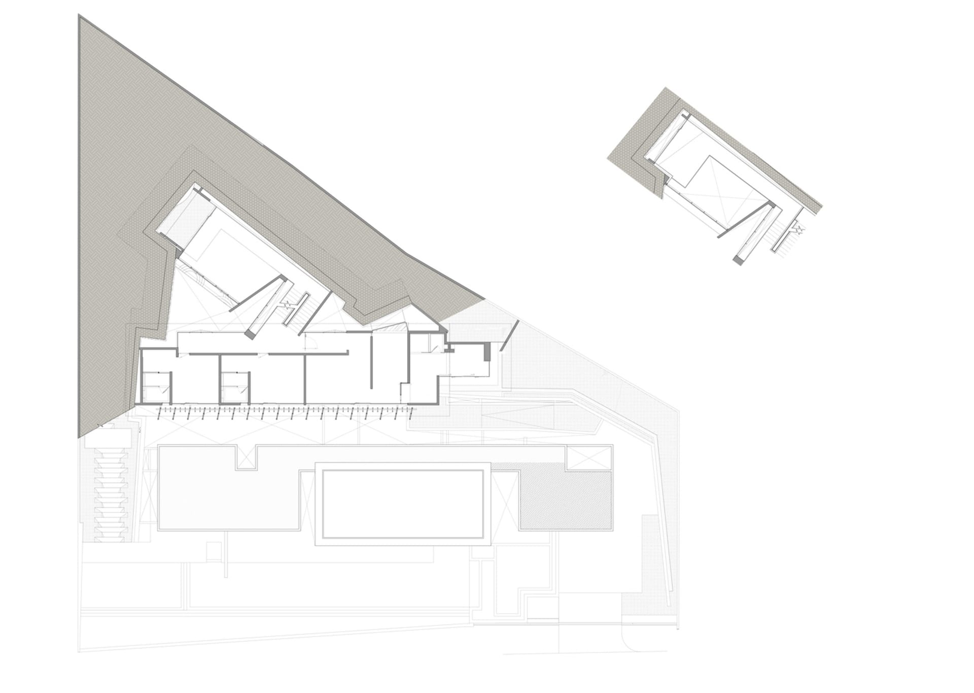 A modern building exterior featuring a concrete facade and roof.