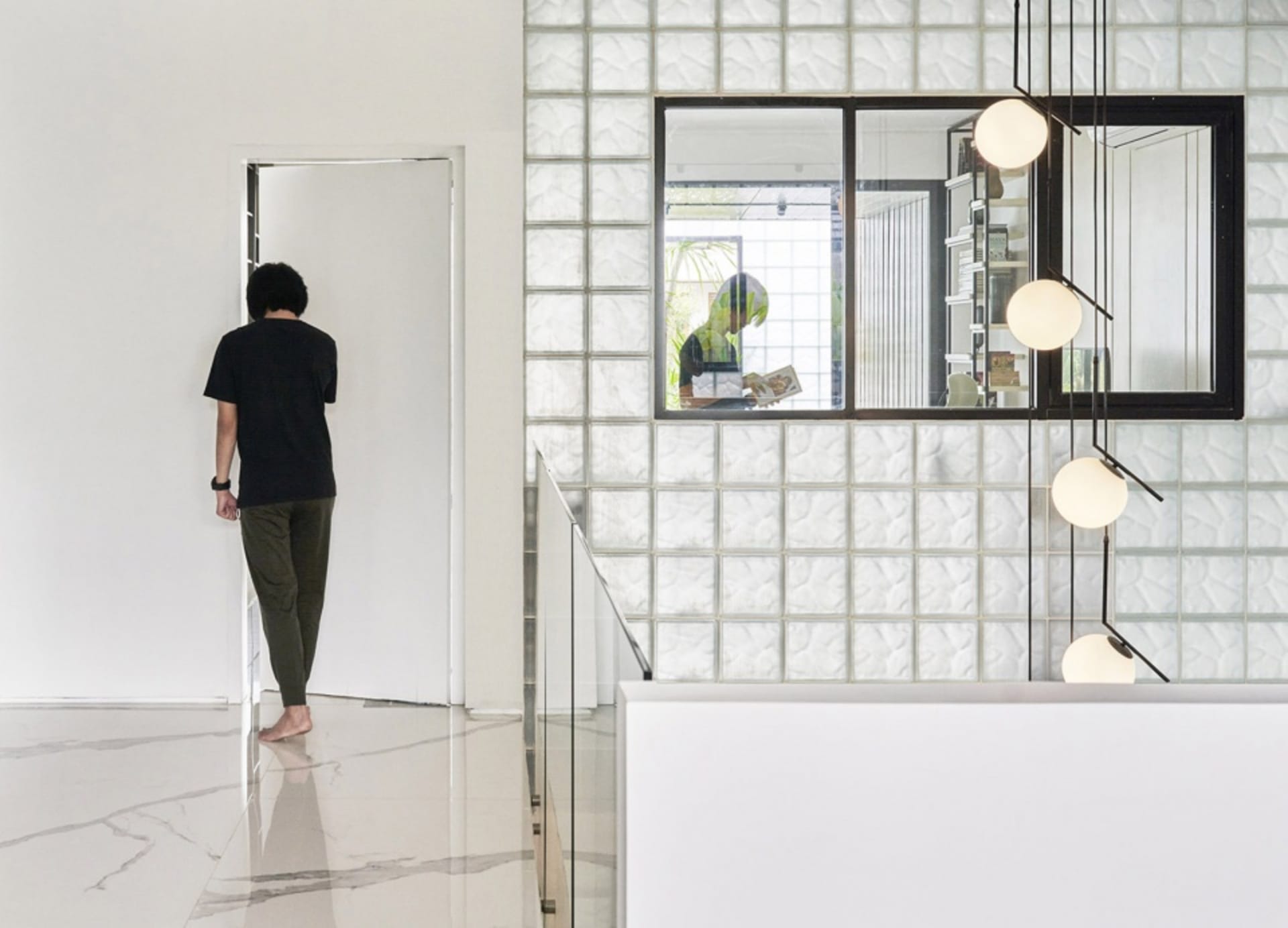 A modern living space featuring textured tile walls and floors.