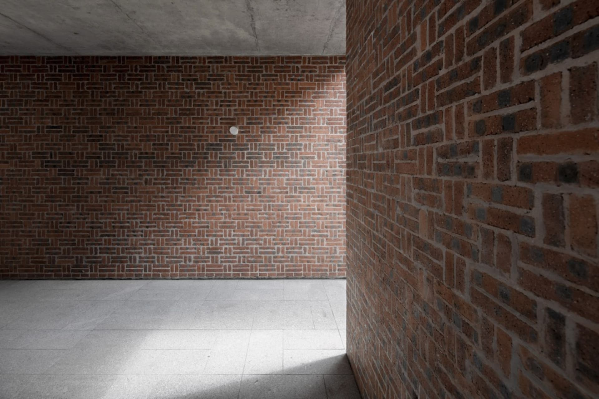 Modern interior design featuring brick walls and pavement