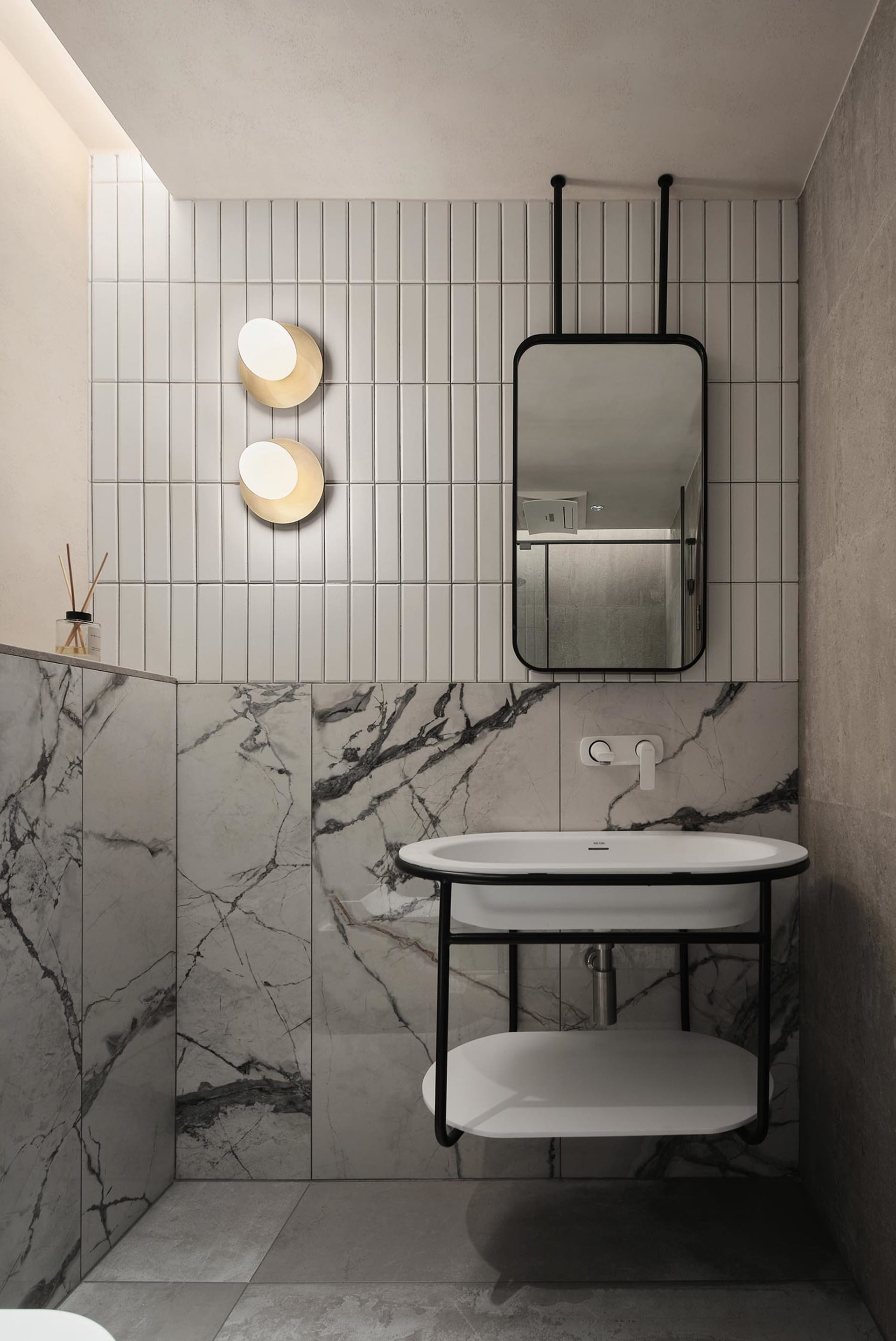 A modern bathroom with marble tiles and a floating vanity.