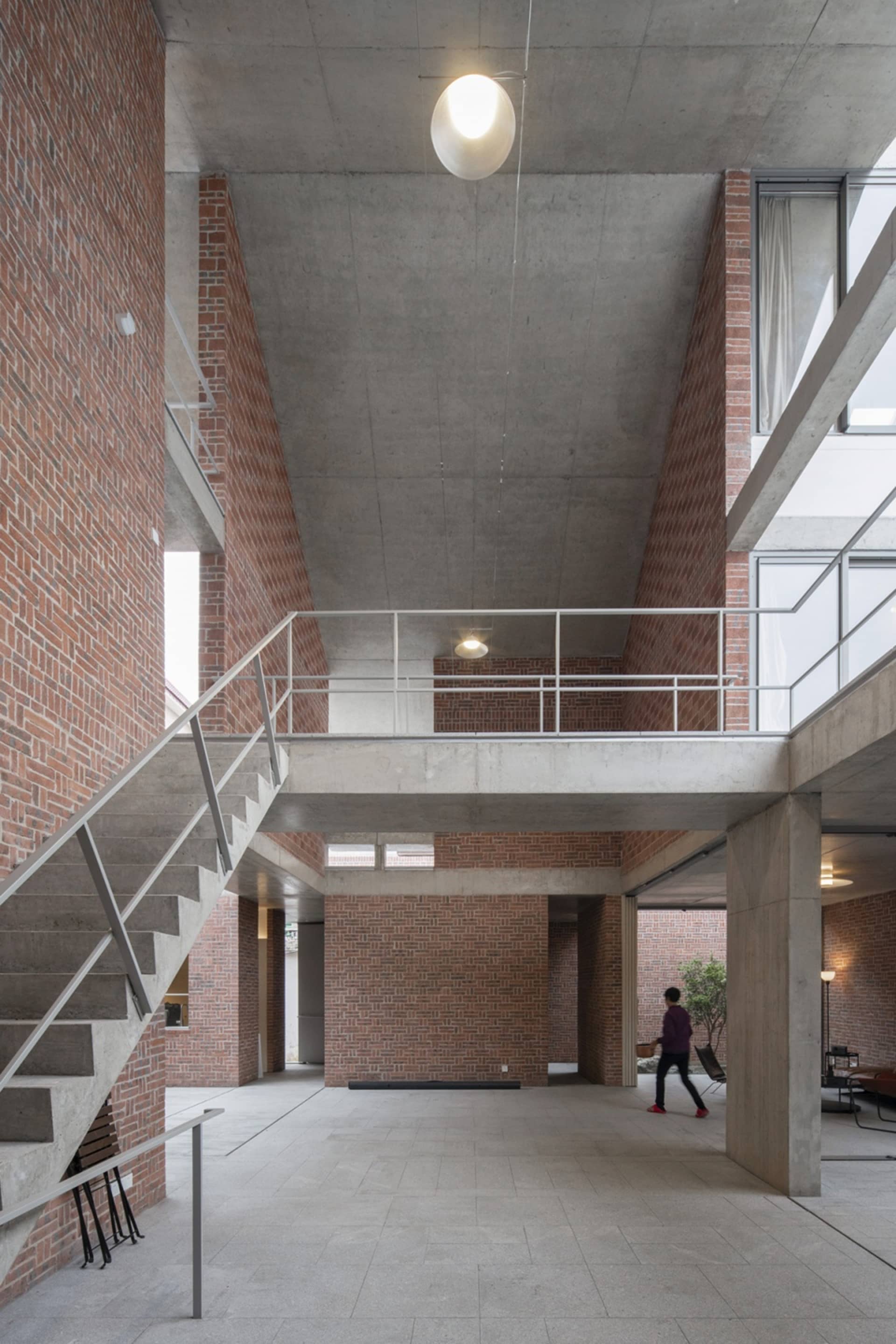 A modern interior space featuring brick and concrete walls.