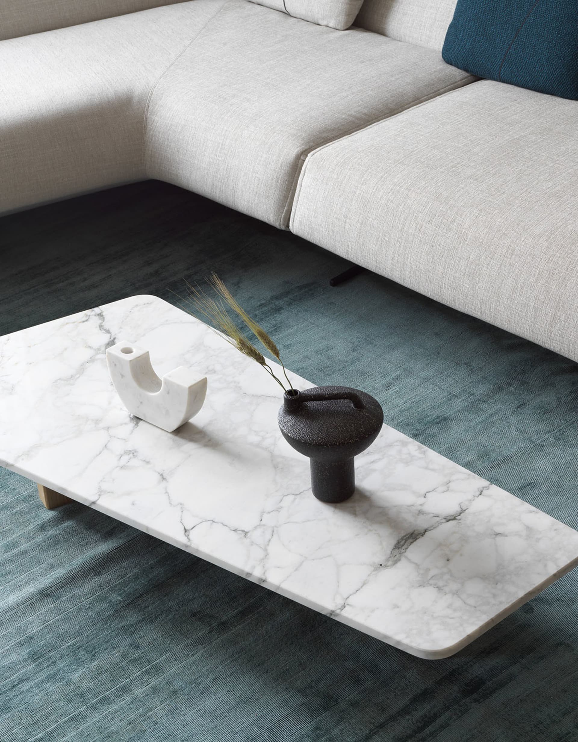 A modern marble living room with a white sofa and a marble coffee table.