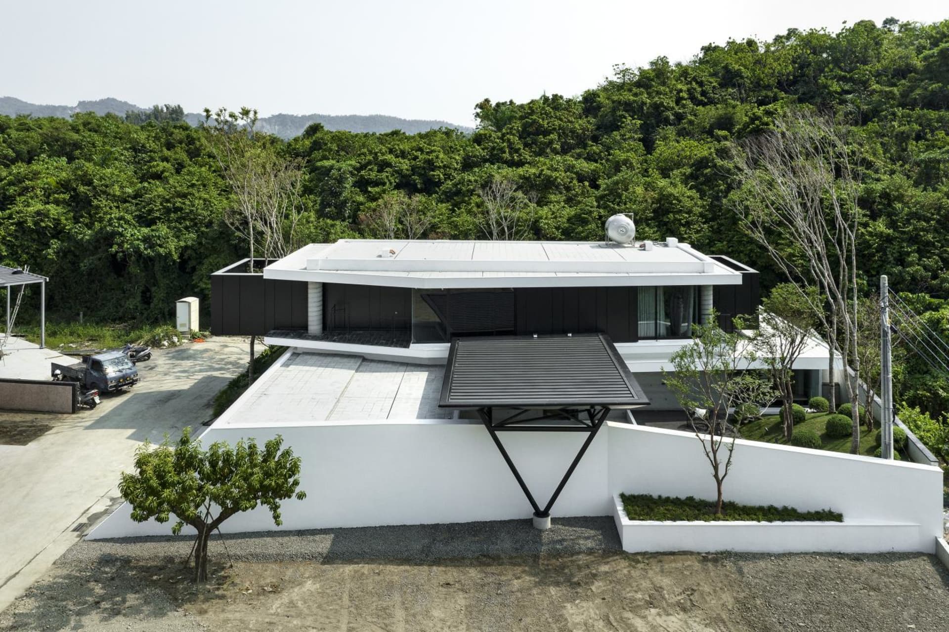 A modern residential building with concrete and glass materials.