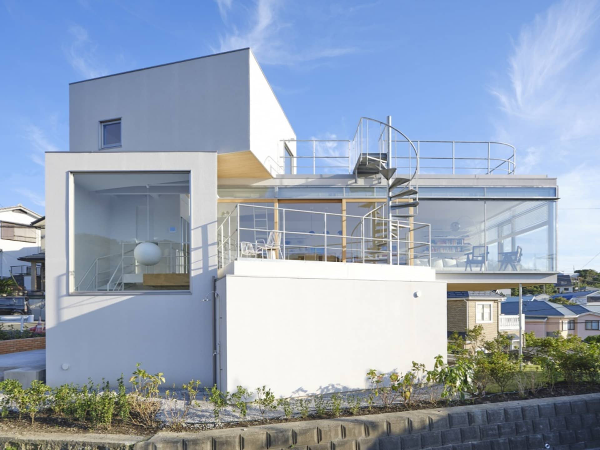 A modern house with a glass and concrete exterior.