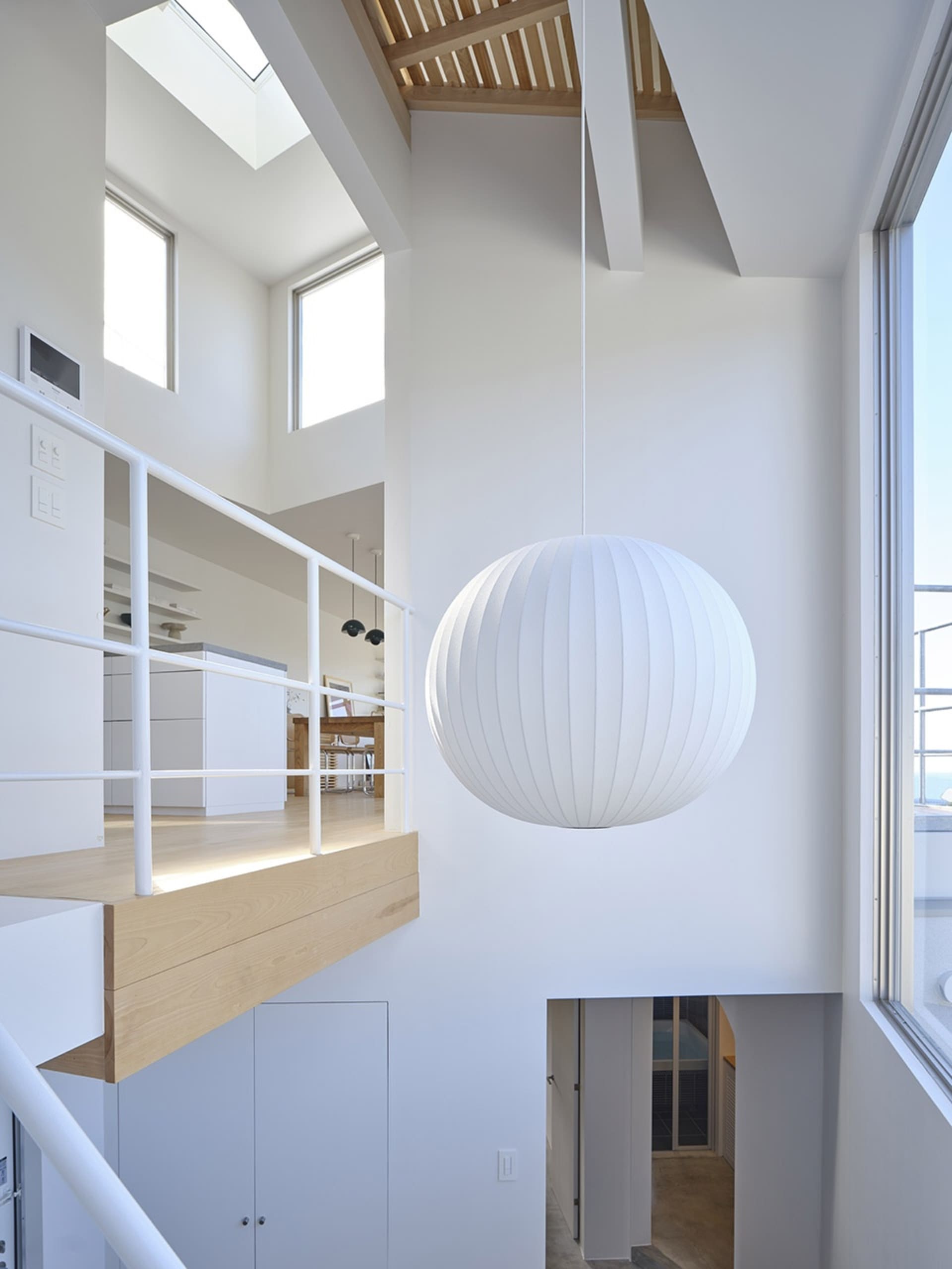 Modern living room featuring metallic white pendant lighting