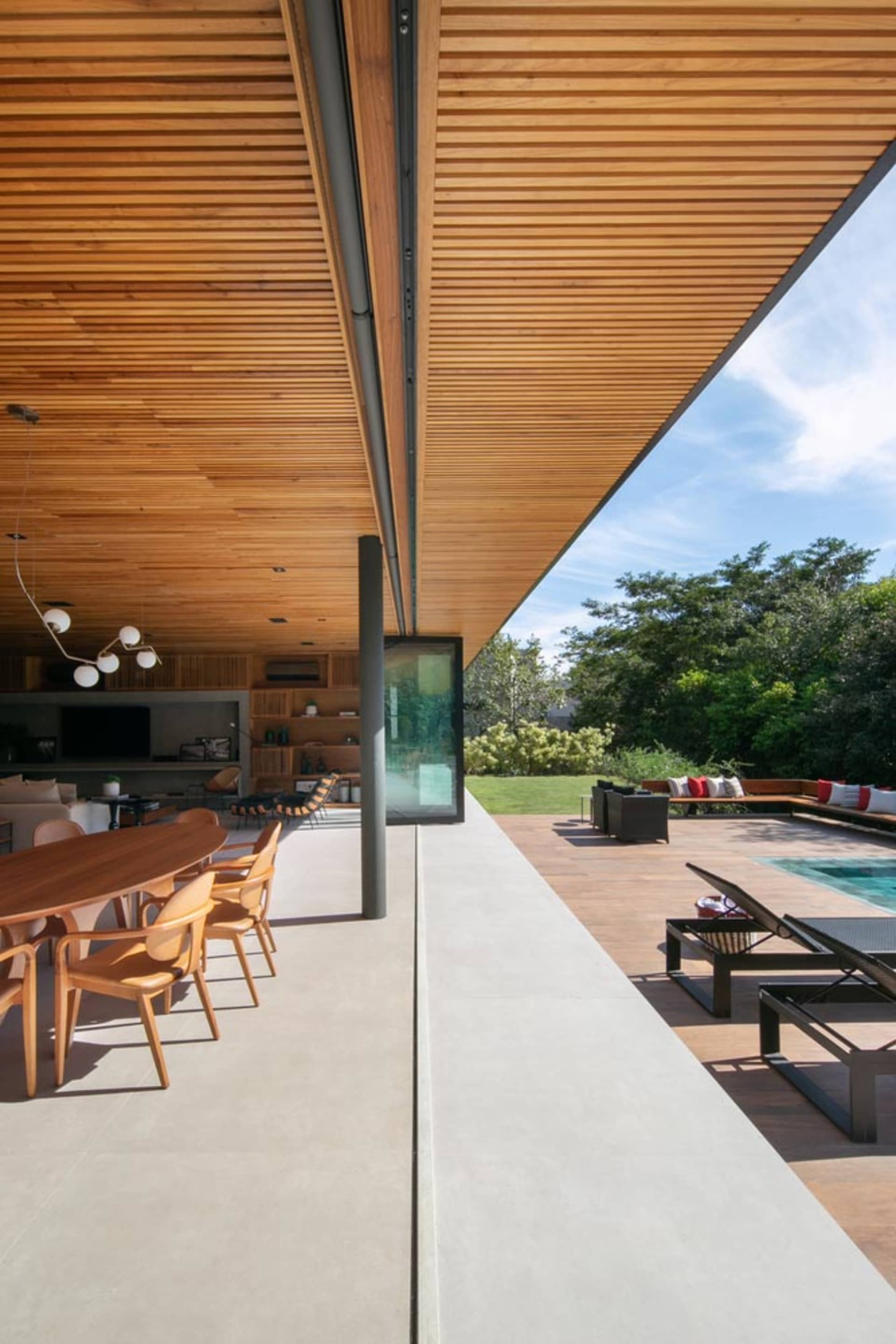 Modern outdoor living space with wooden planks, steel, and concrete