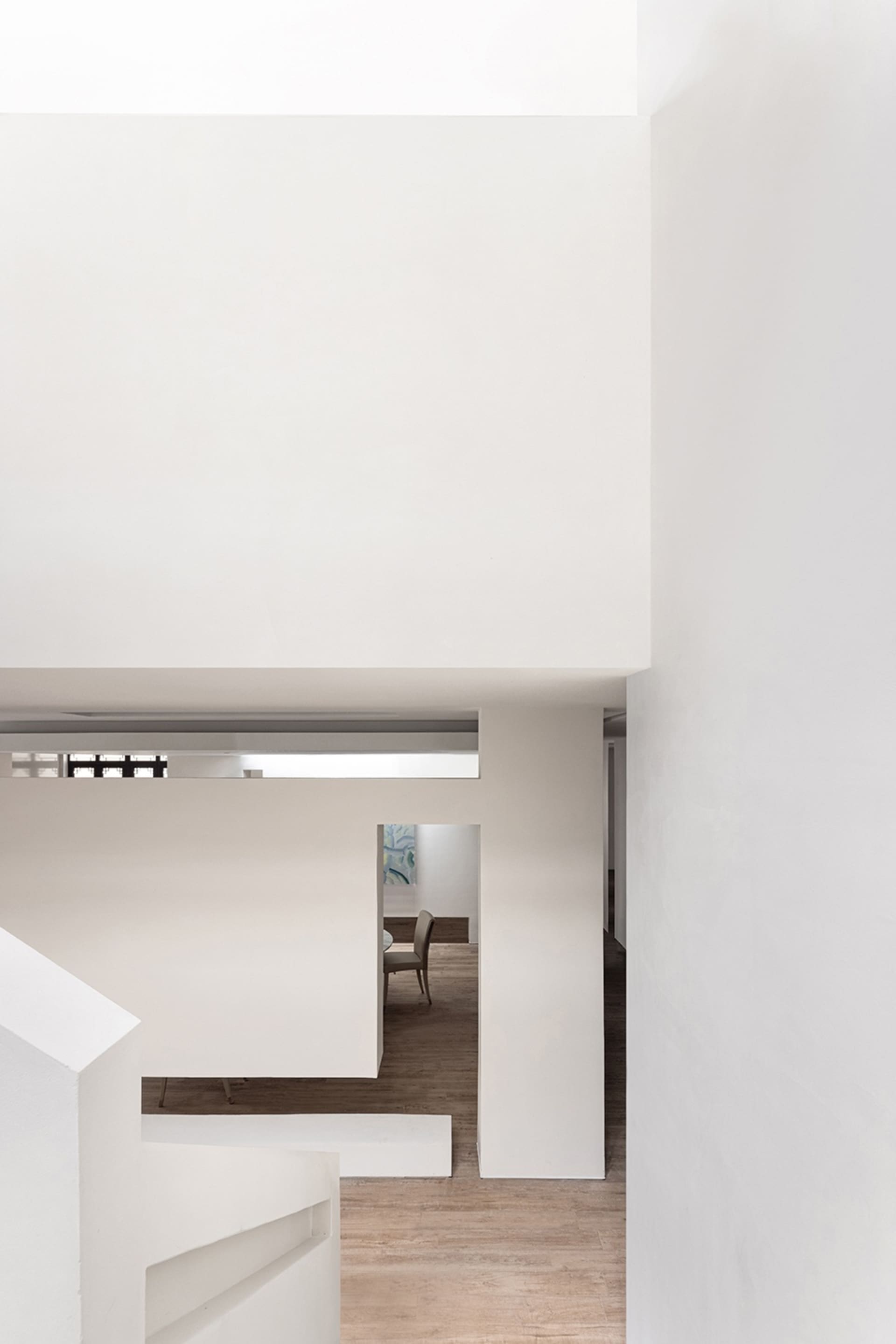 A minimalist white concrete residential interior with a modern and airy design.