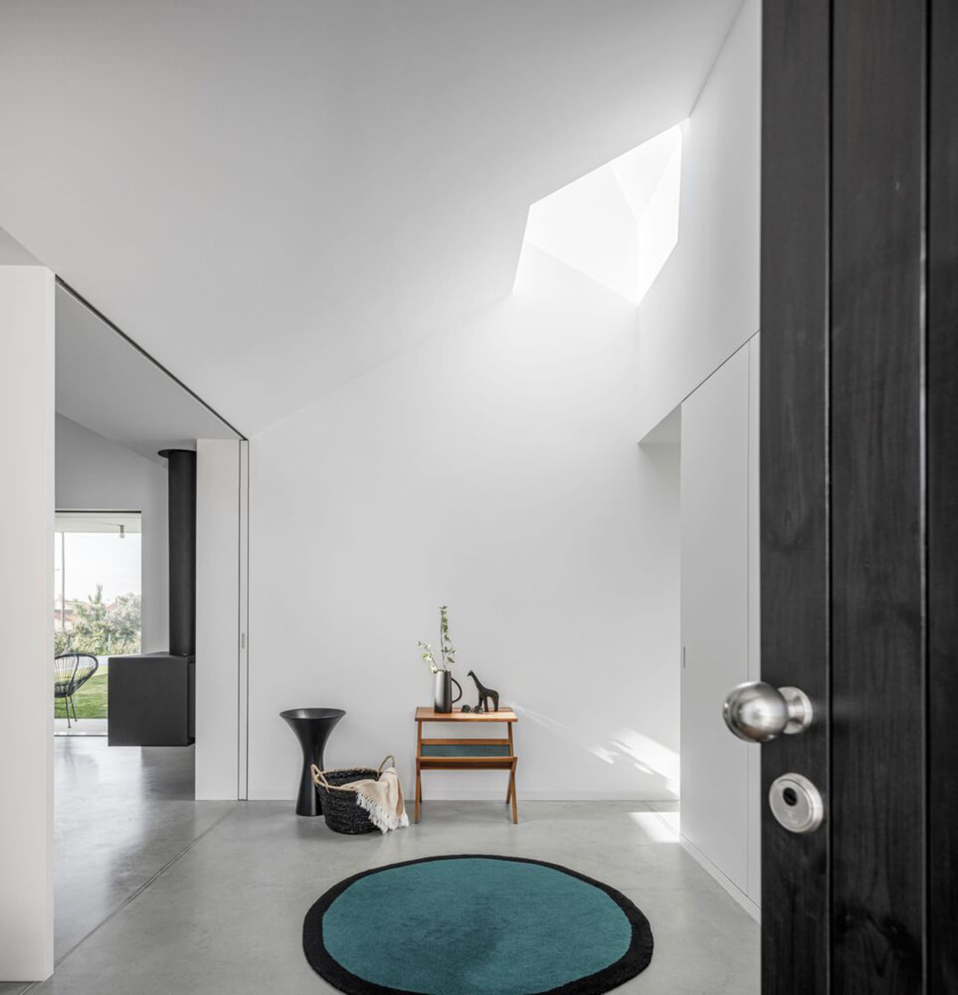 Modern entrance hallway featuring a concrete floor and minimalist design.