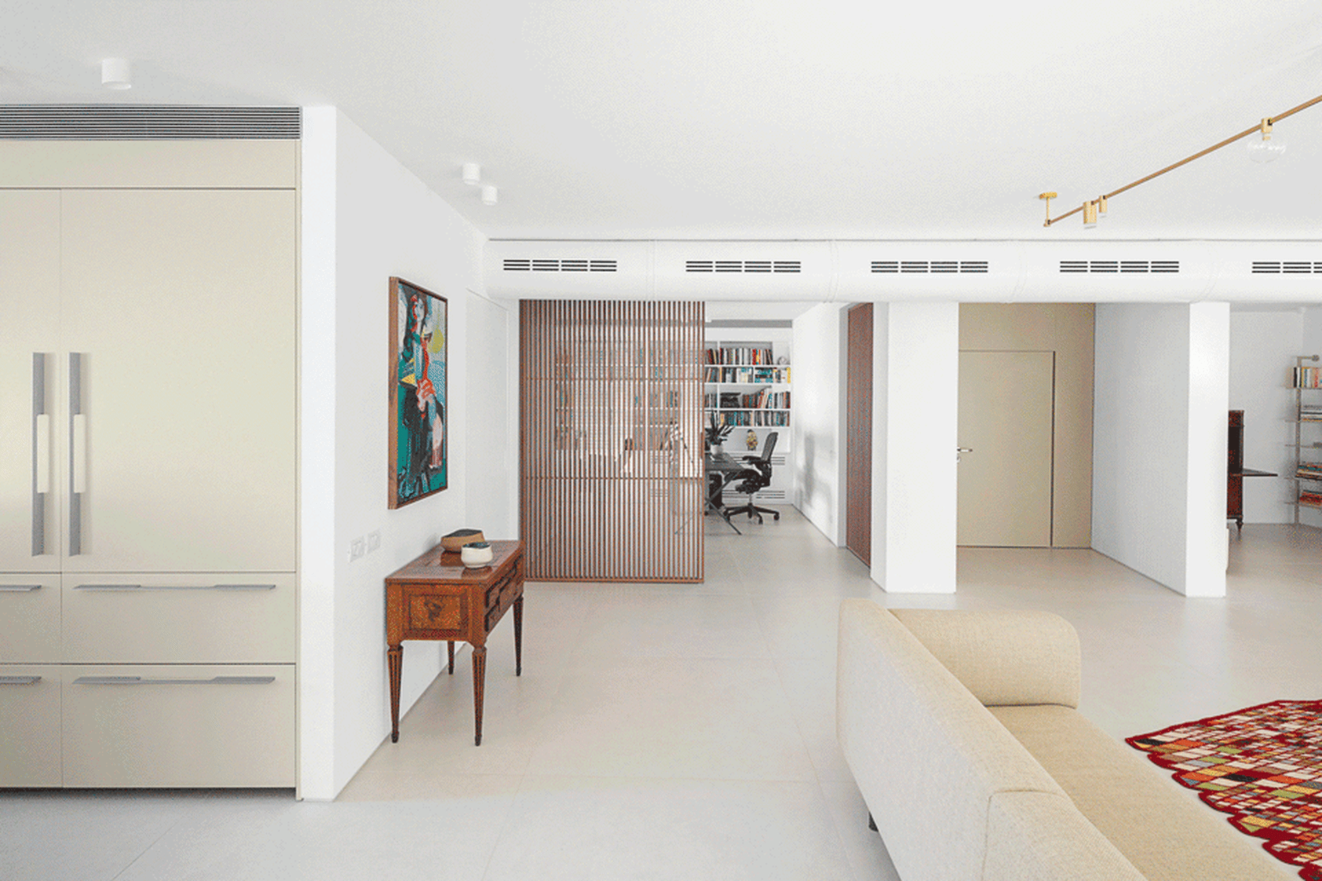 Modern living room with white interior design, contemporary furniture, and minimalist decor.