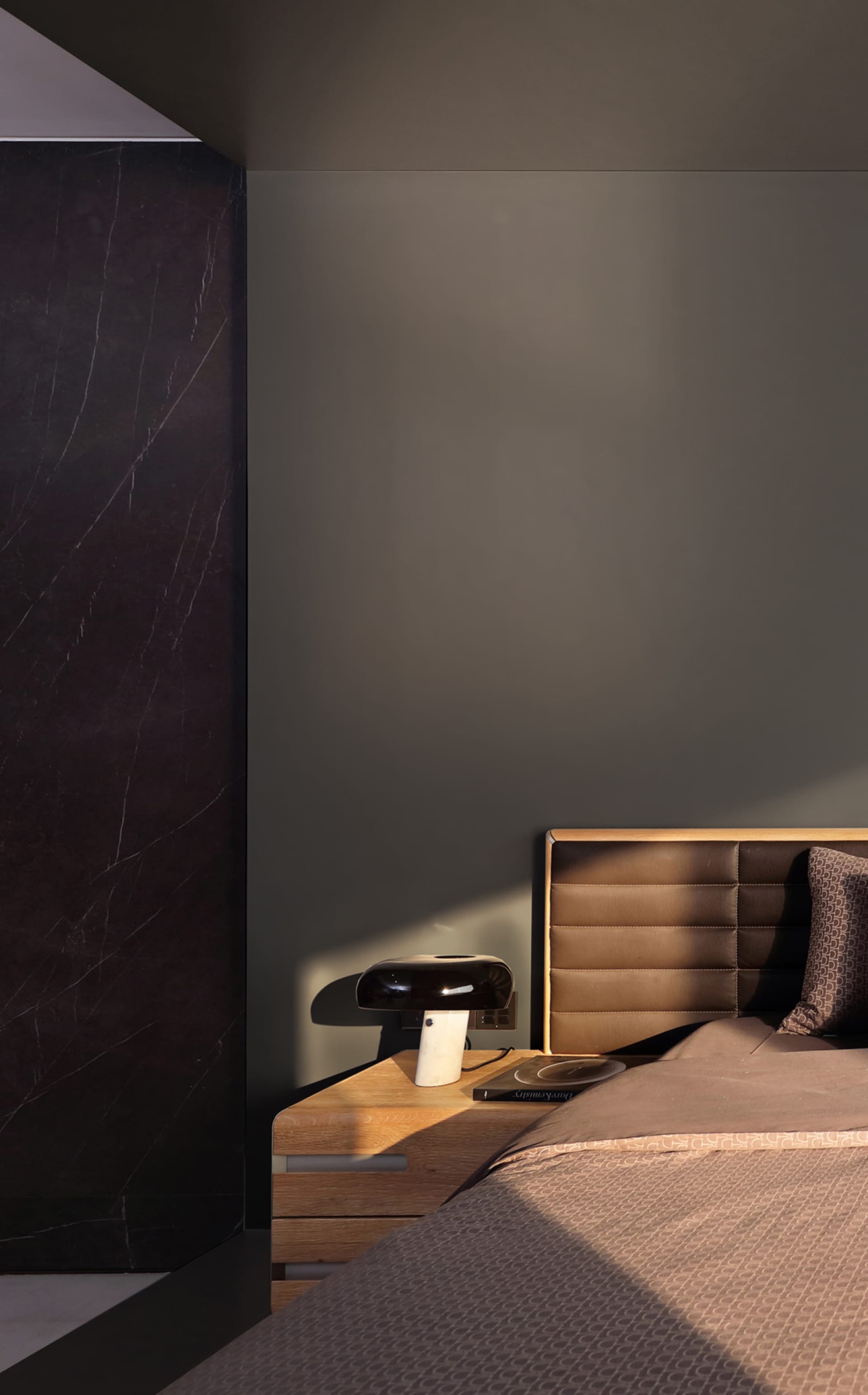 Modern minimalist bedroom featuring marble and leather finishes