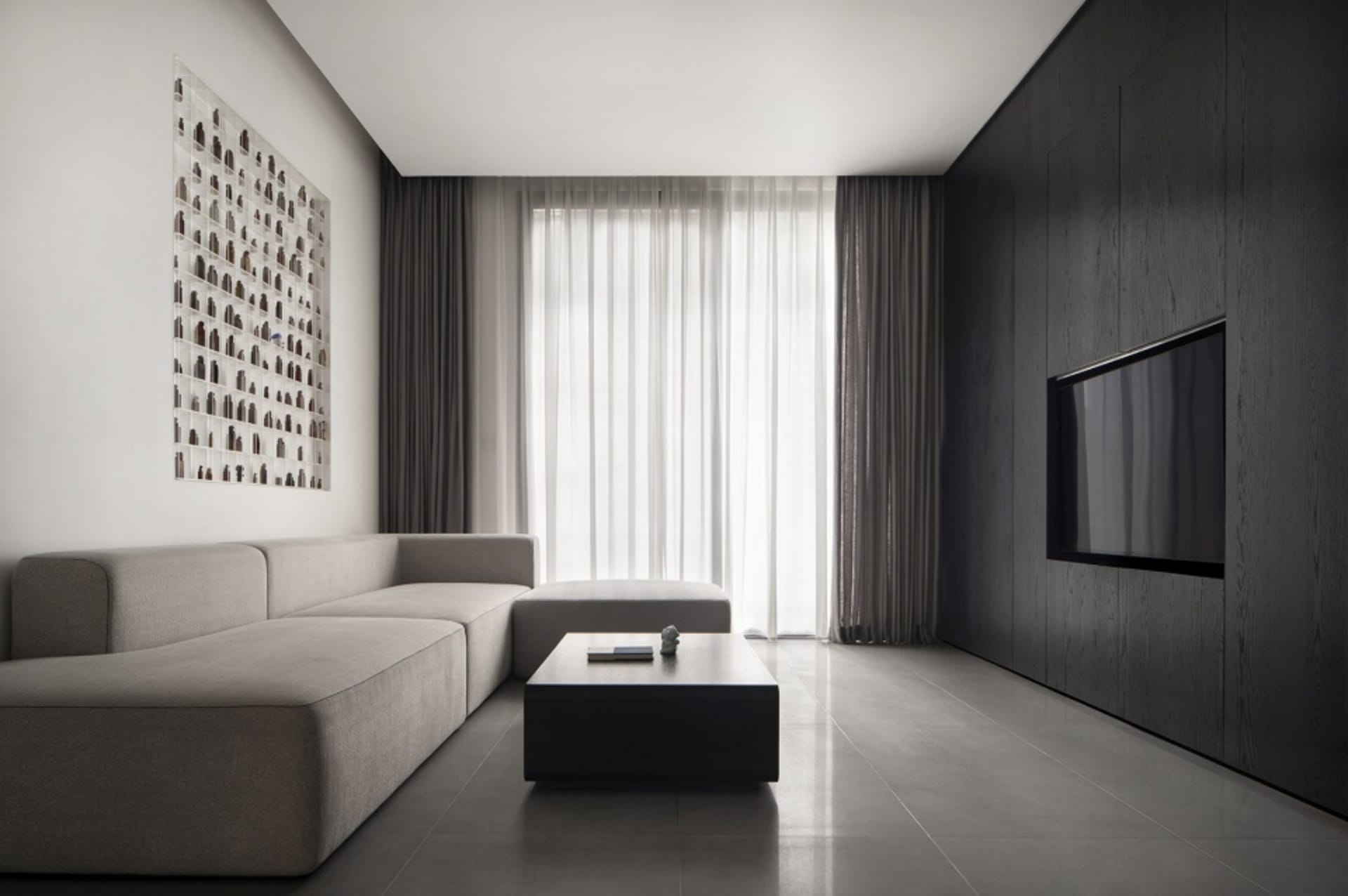 Modern minimalist living room featuring metallic accents, glass windows, and upholstered furniture.