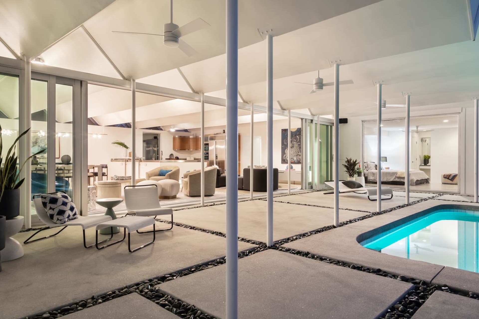 Modern residential interior design featuring white furniture and white walls.