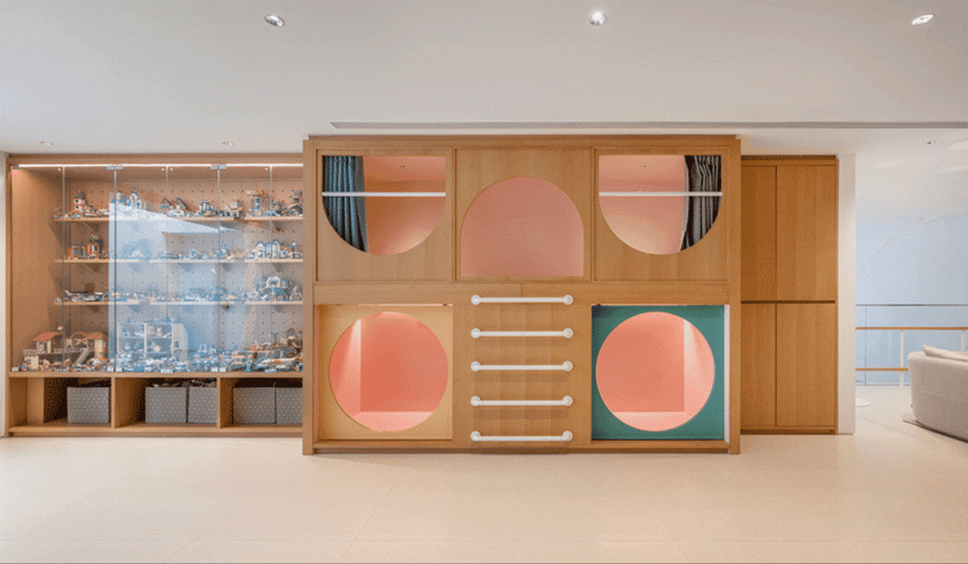 A modern interior space featuring a wooden display case filled with various objects.
