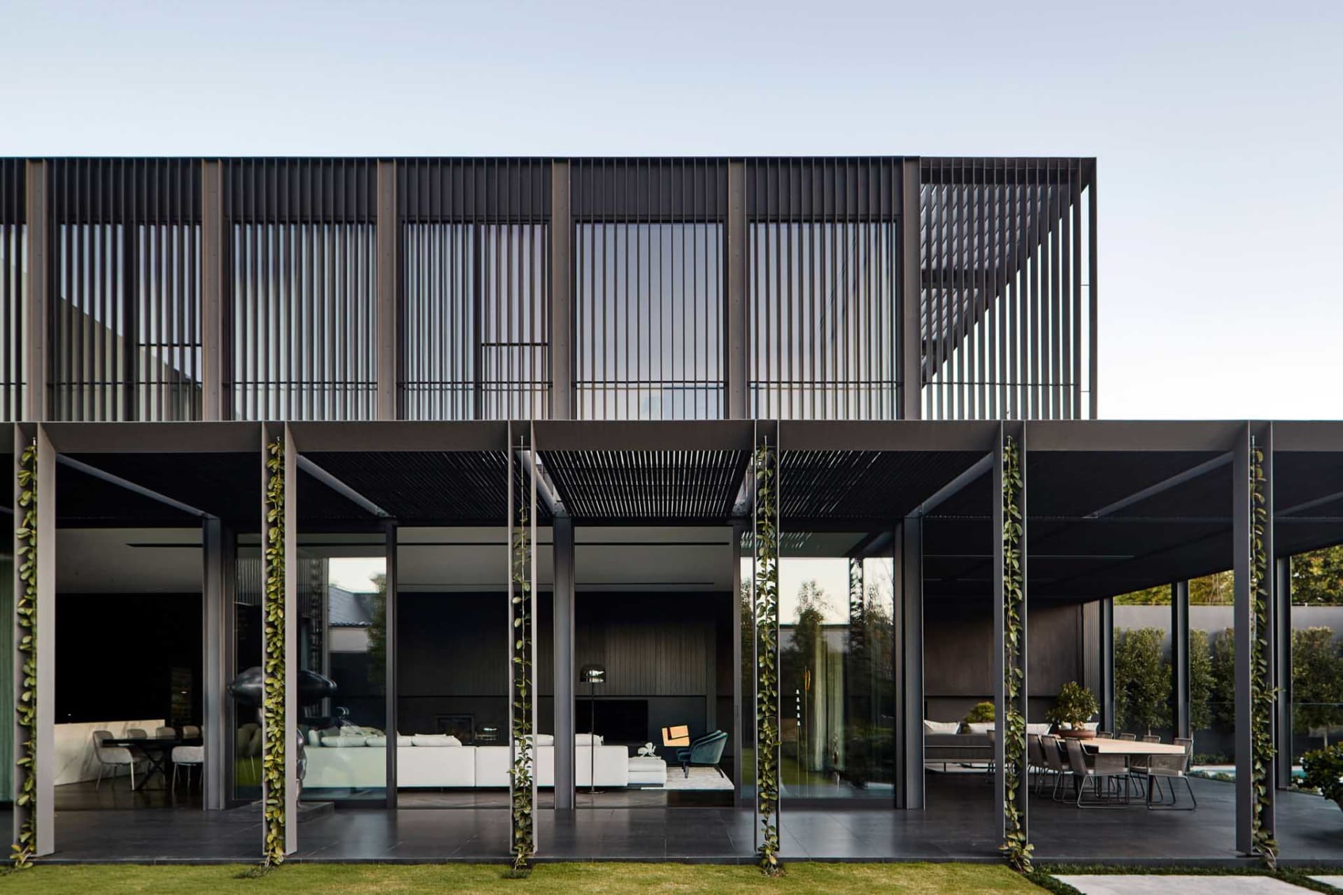 Modern building with metal overhangs, glass panels, and concrete floors.