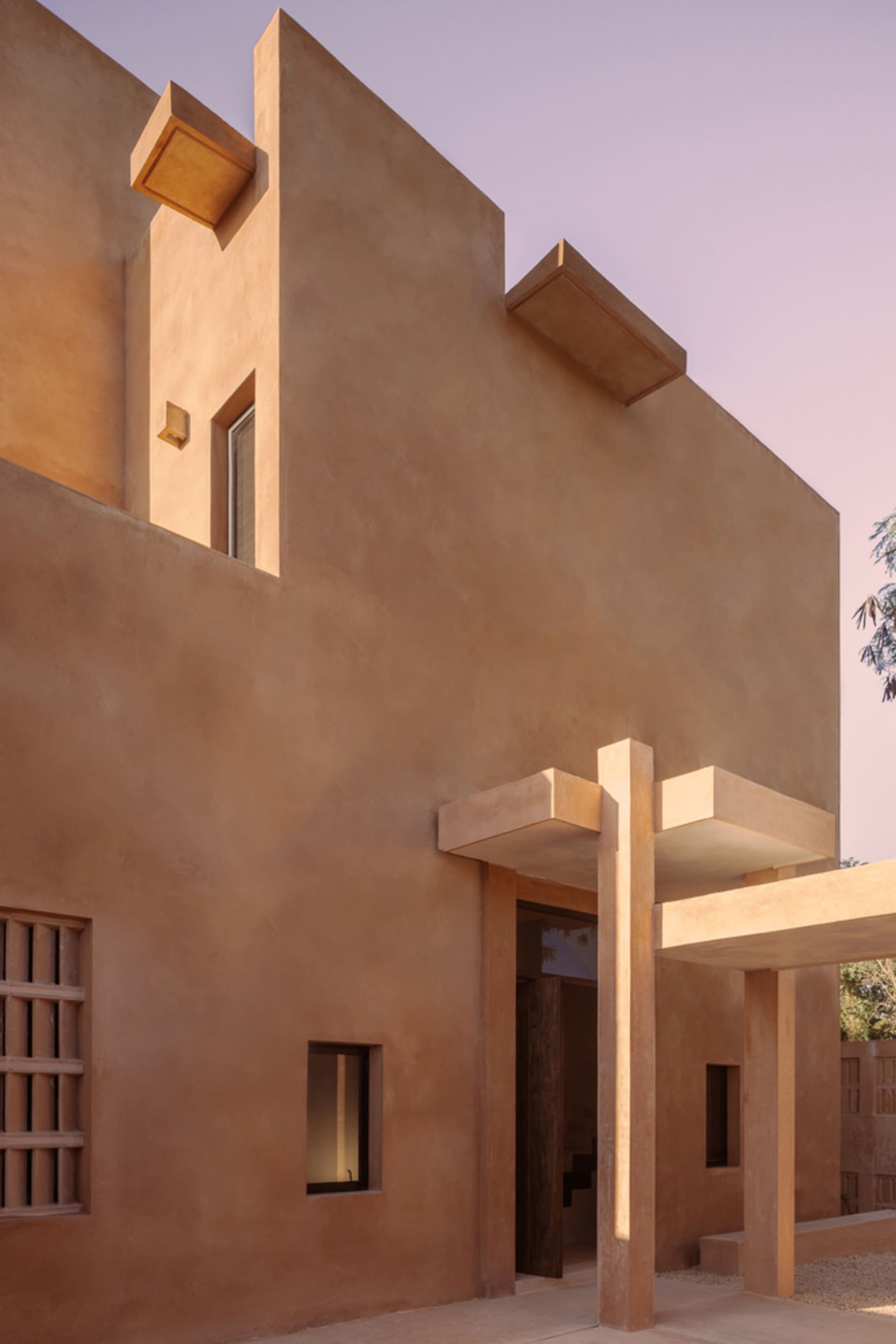 Modern exterior architecture with clay walls and minimalist design elements.