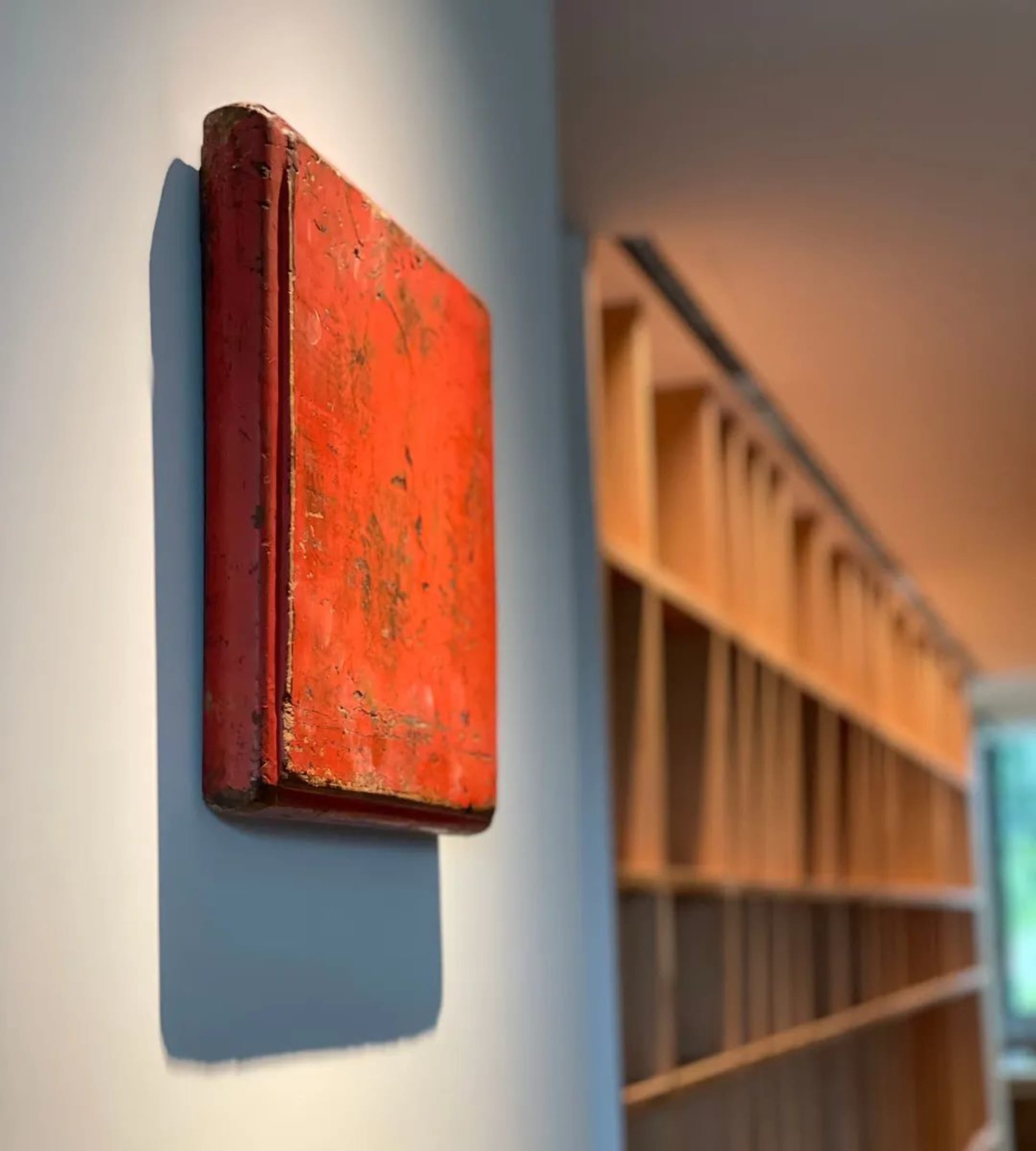 A red box mounted on a white wall in an industrial setting.