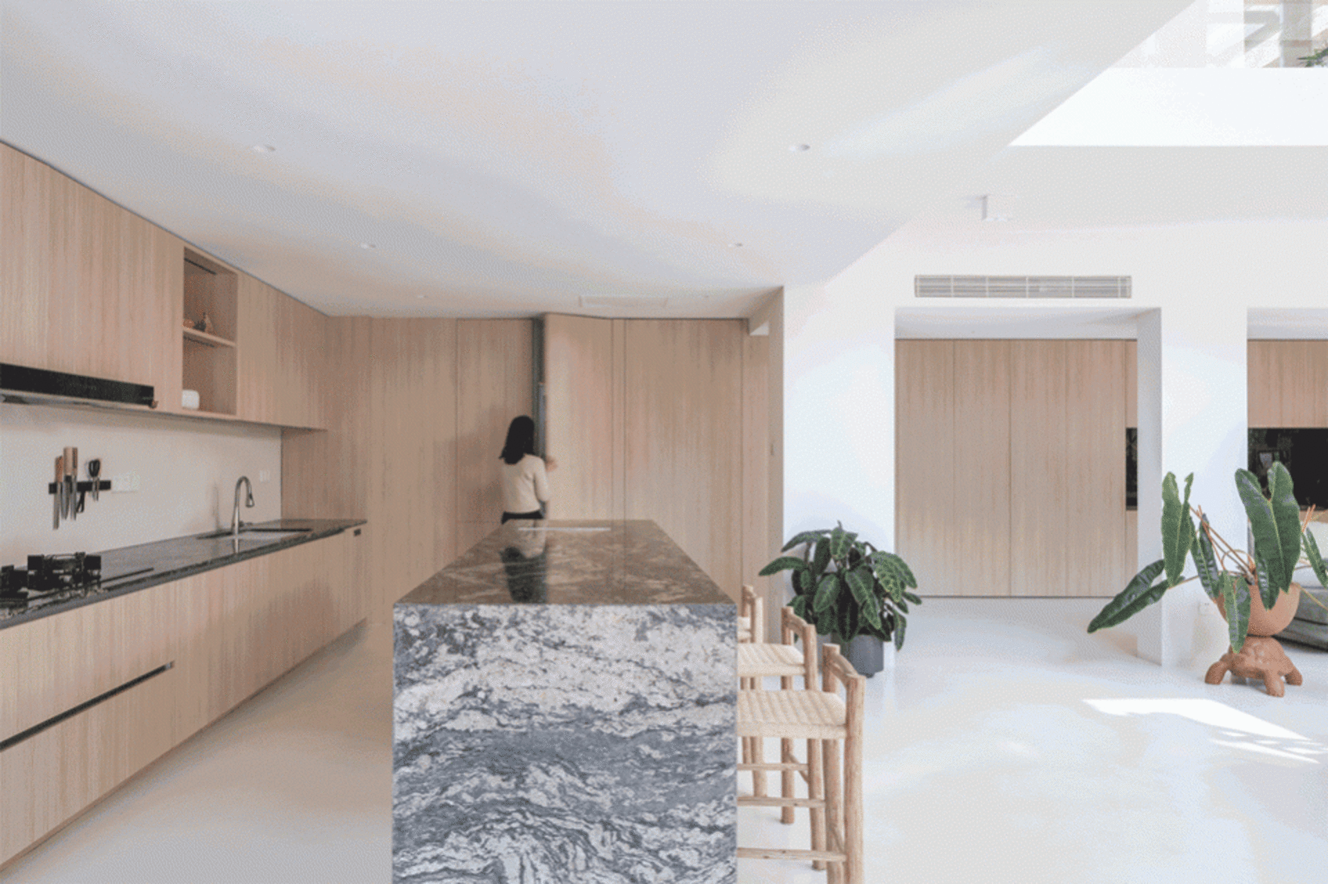 Modern kitchen with wooden cabinetry and a marble island