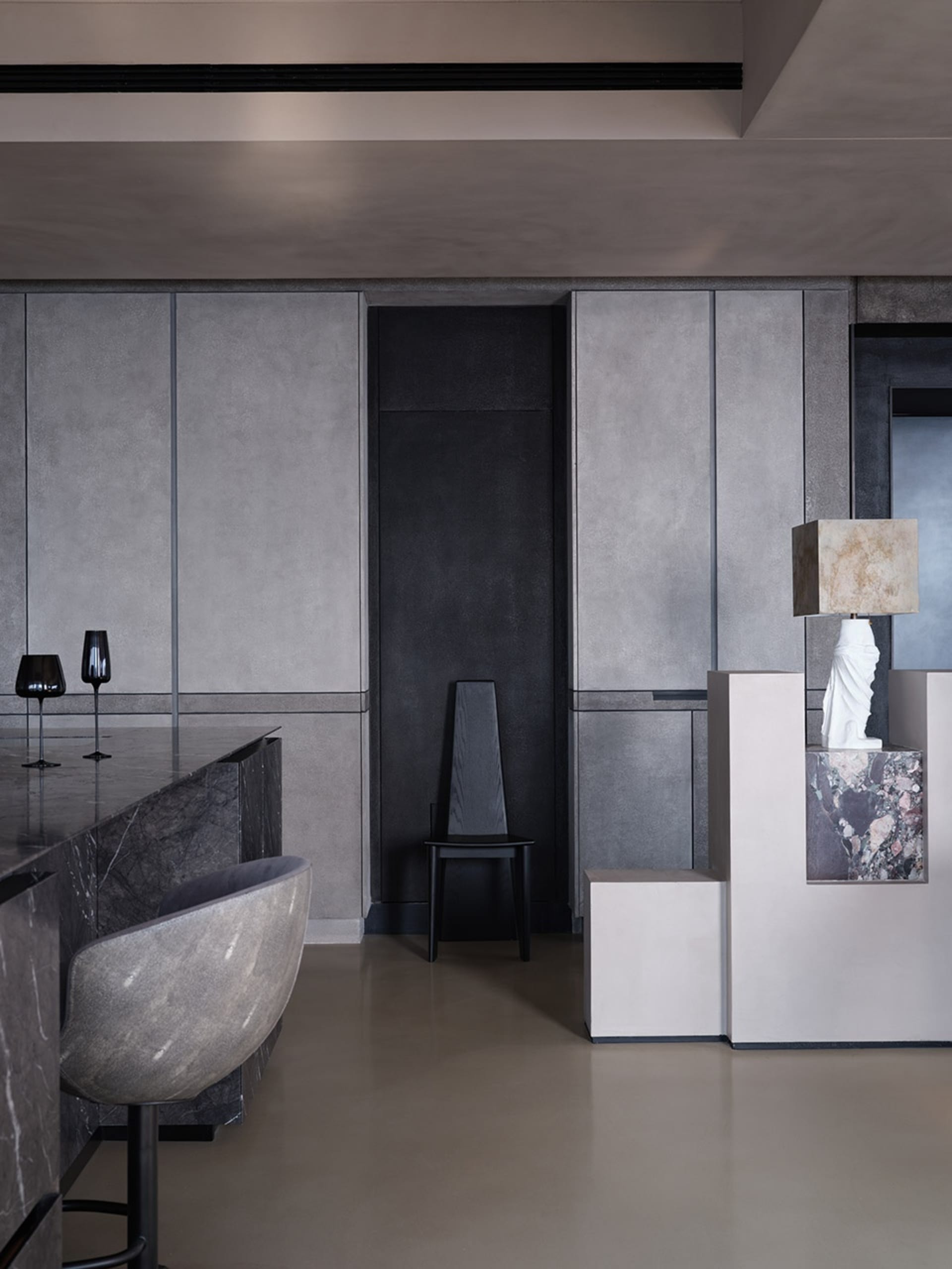 A modern interior design featuring marble and metal finishes.