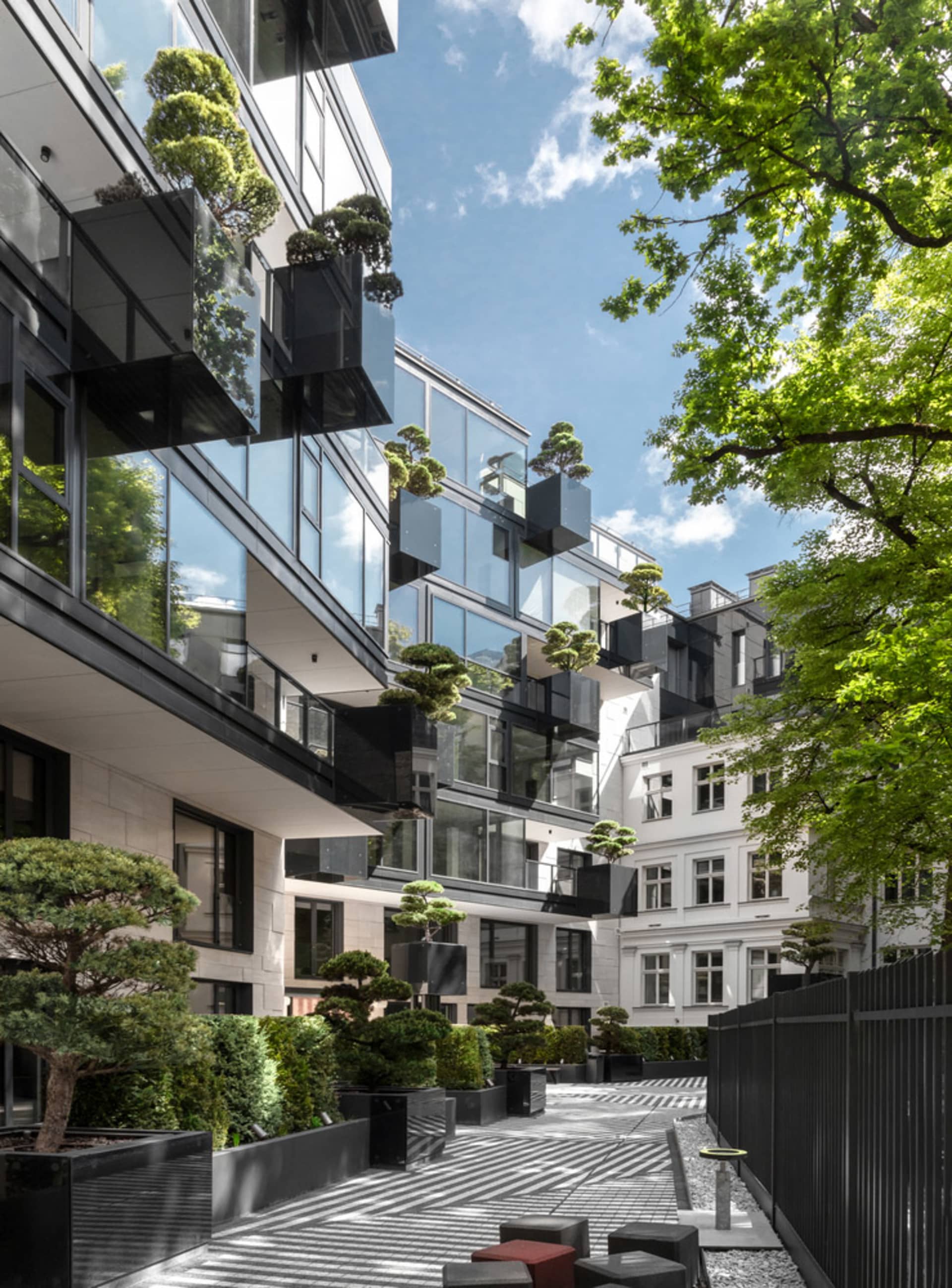 Modern residential building with glass and concrete materials.