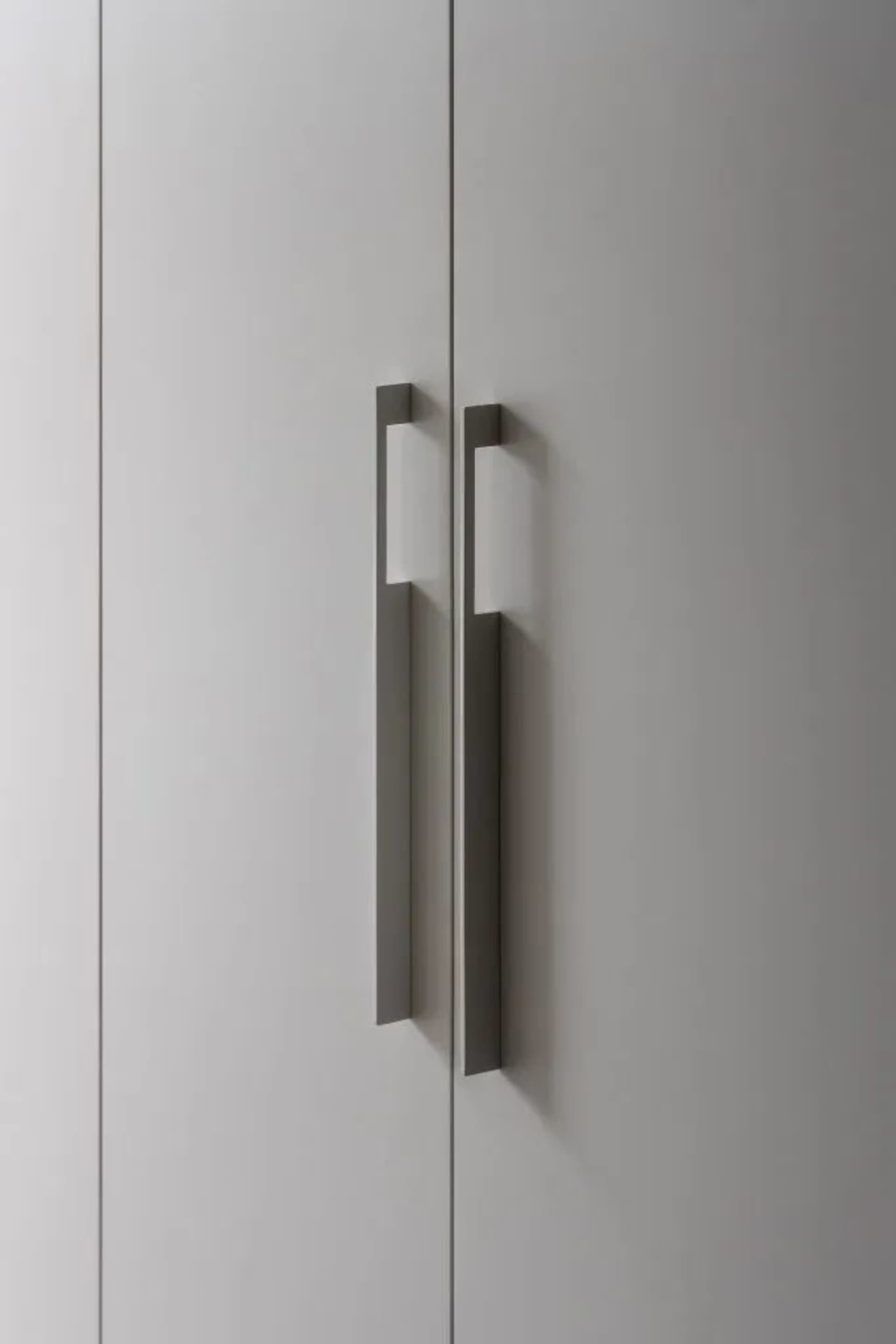 Modern minimalist kitchen or bathroom cabinetry with metal handles
